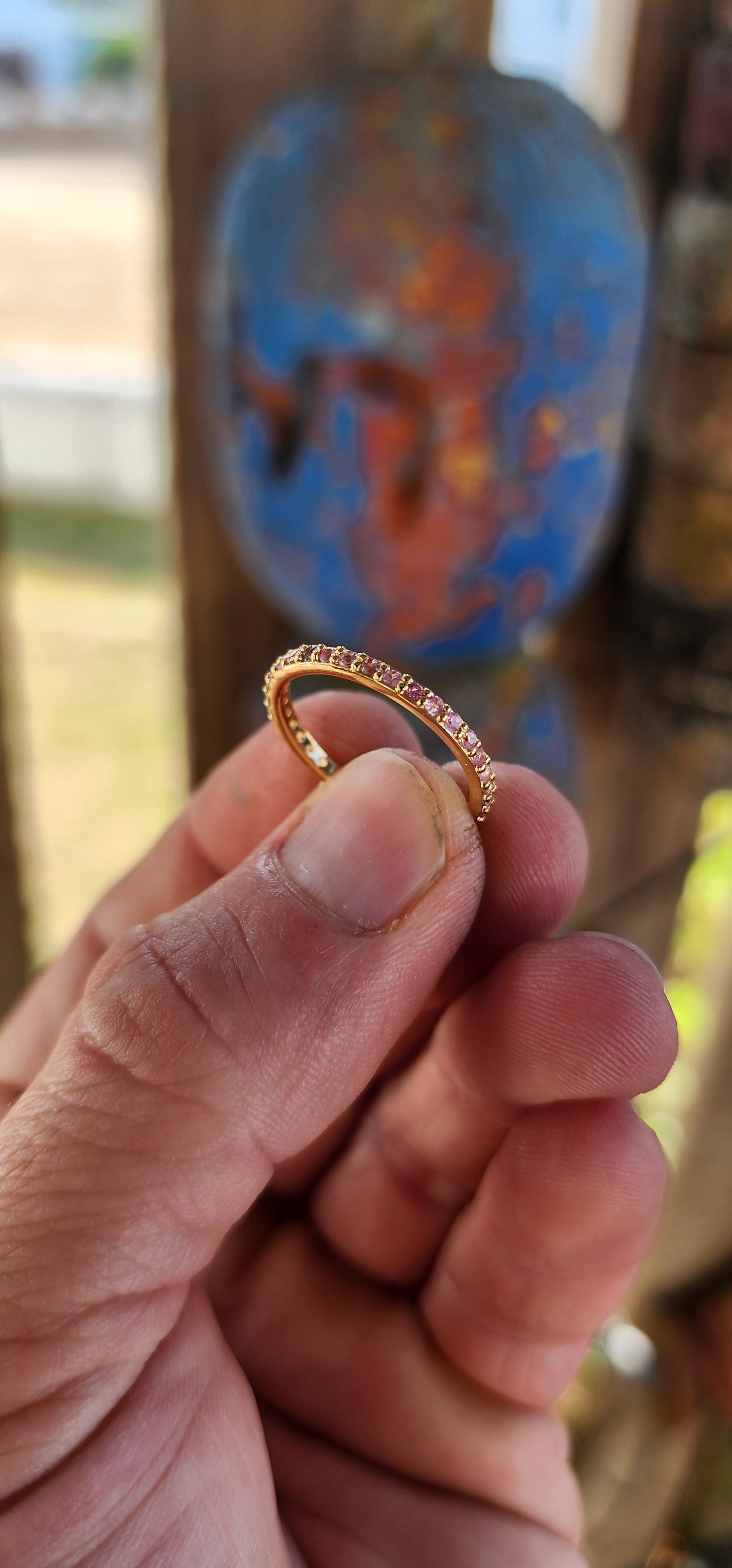 A sterling silver full eternity stacking ring, luxuriously plated in 18ct yellow gold and adorned with a continuous circle of sparkling Pink Sapphires.