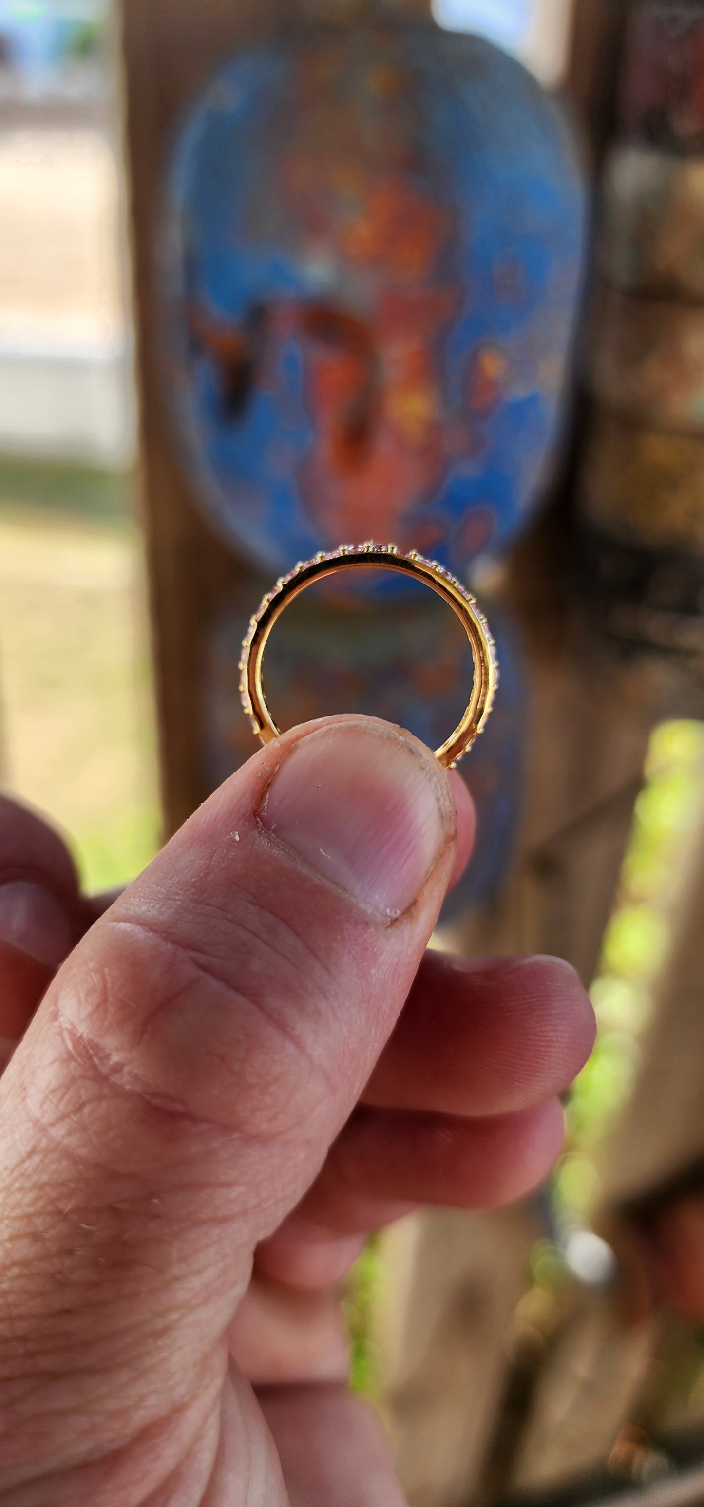 A sterling silver full eternity stacking ring, luxuriously plated in 18ct yellow gold and adorned with a continuous circle of sparkling Pink Sapphires.