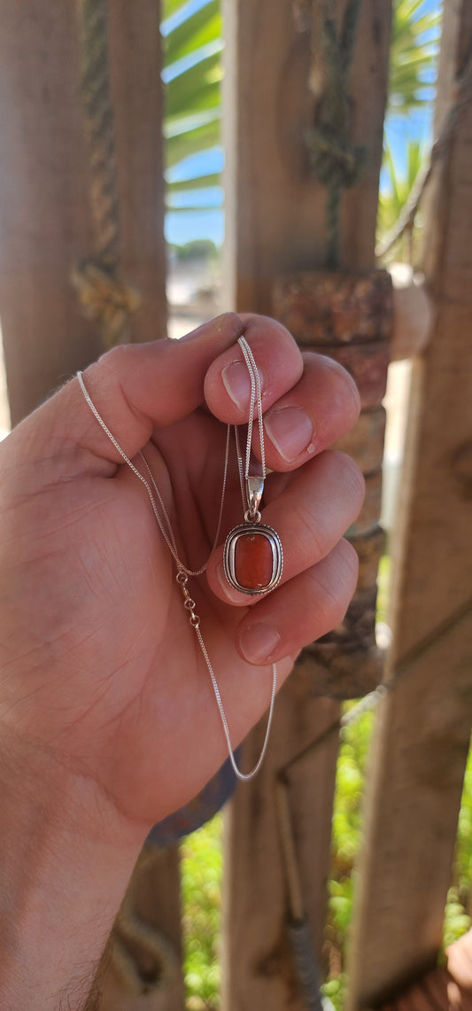 A quietly powerful and deeply soulful vintage unisex pendant, crafted in solid sterling silver and set with a natural Mediterranean coral cabochon sourced from the Italian coast.