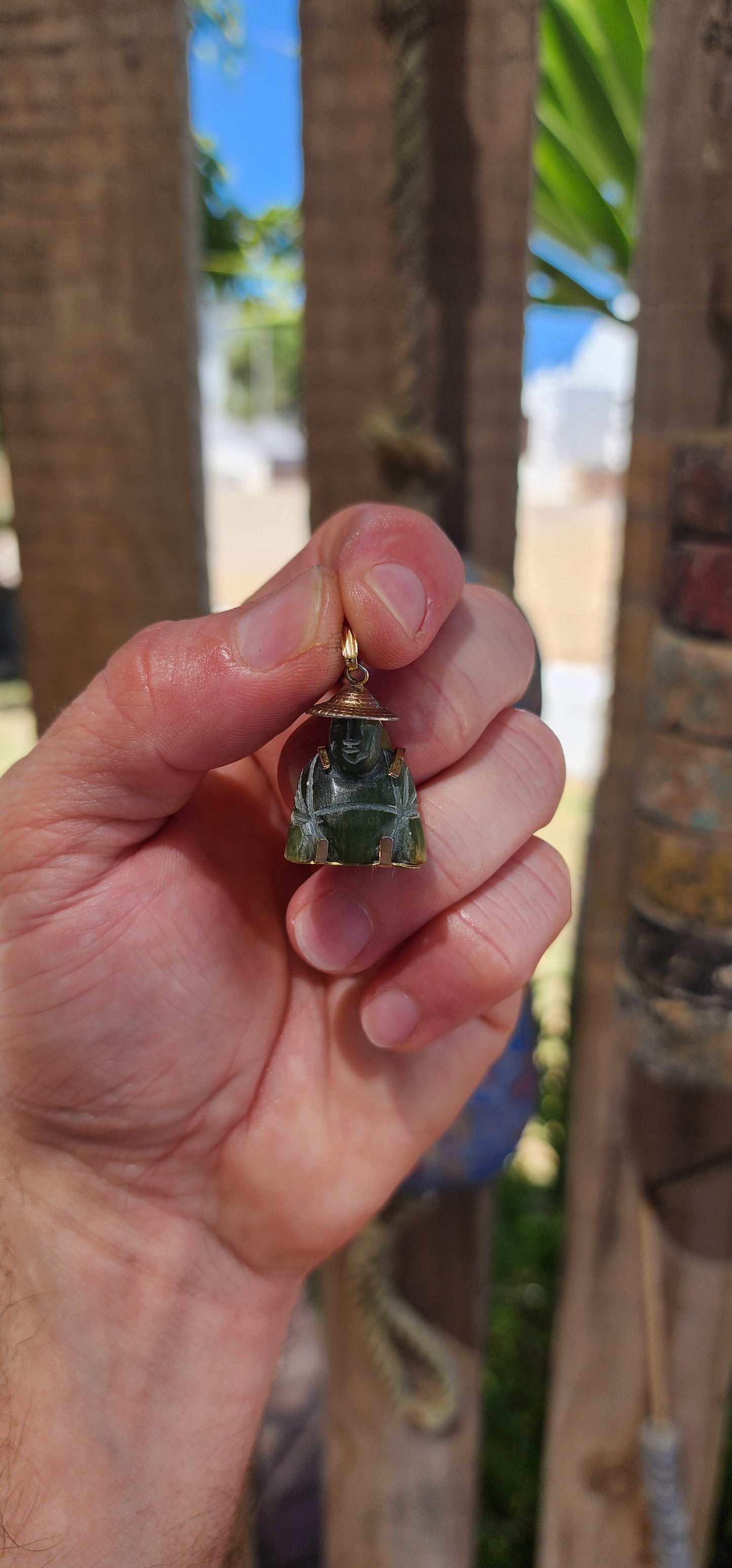 A delightful miniature Buddha pendant, carved from rich nephrite spinach jade and dating to the 1980s. Small in scale but big in character, this charming little figure is full of old-world symbolism.