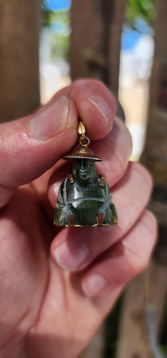 A delightful miniature Buddha pendant, carved from rich nephrite spinach jade and dating to the 1980s. Small in scale but big in character, this charming little figure is full of old-world symbolism.