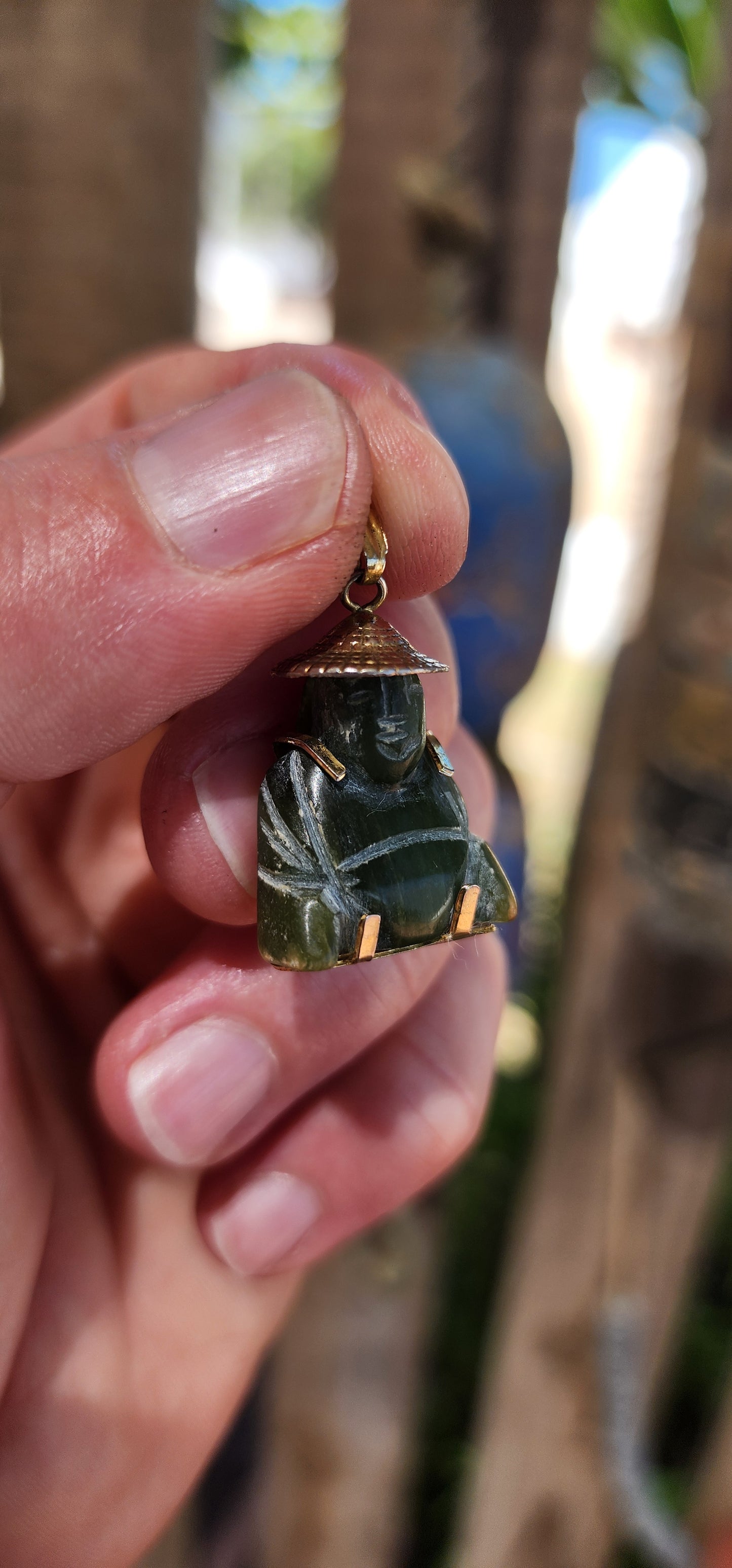 A delightful miniature Buddha pendant, carved from rich nephrite spinach jade and dating to the 1980s. Small in scale but big in character, this charming little figure is full of old-world symbolism.