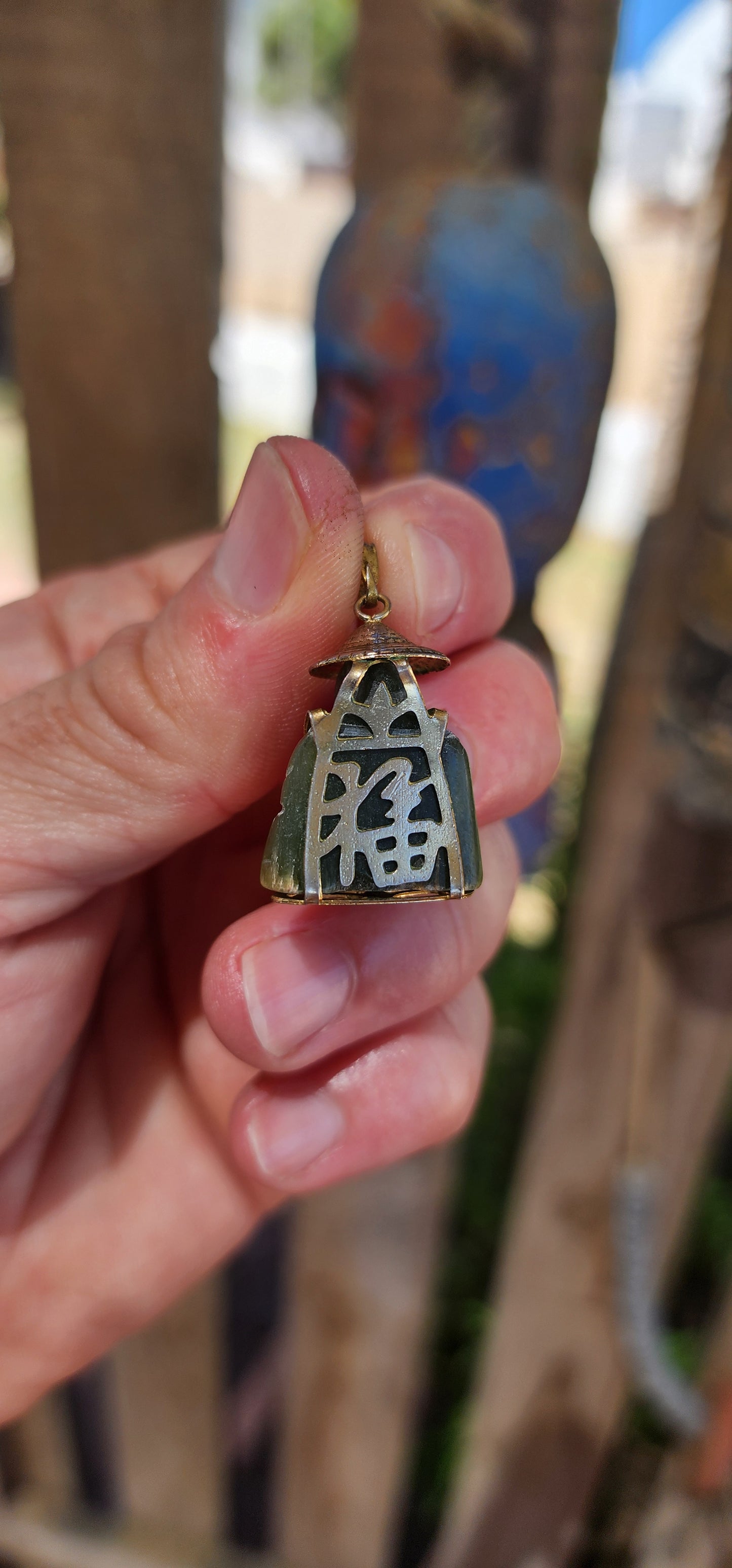 A delightful miniature Buddha pendant, carved from rich nephrite spinach jade and dating to the 1980s. Small in scale but big in character, this charming little figure is full of old-world symbolism.
