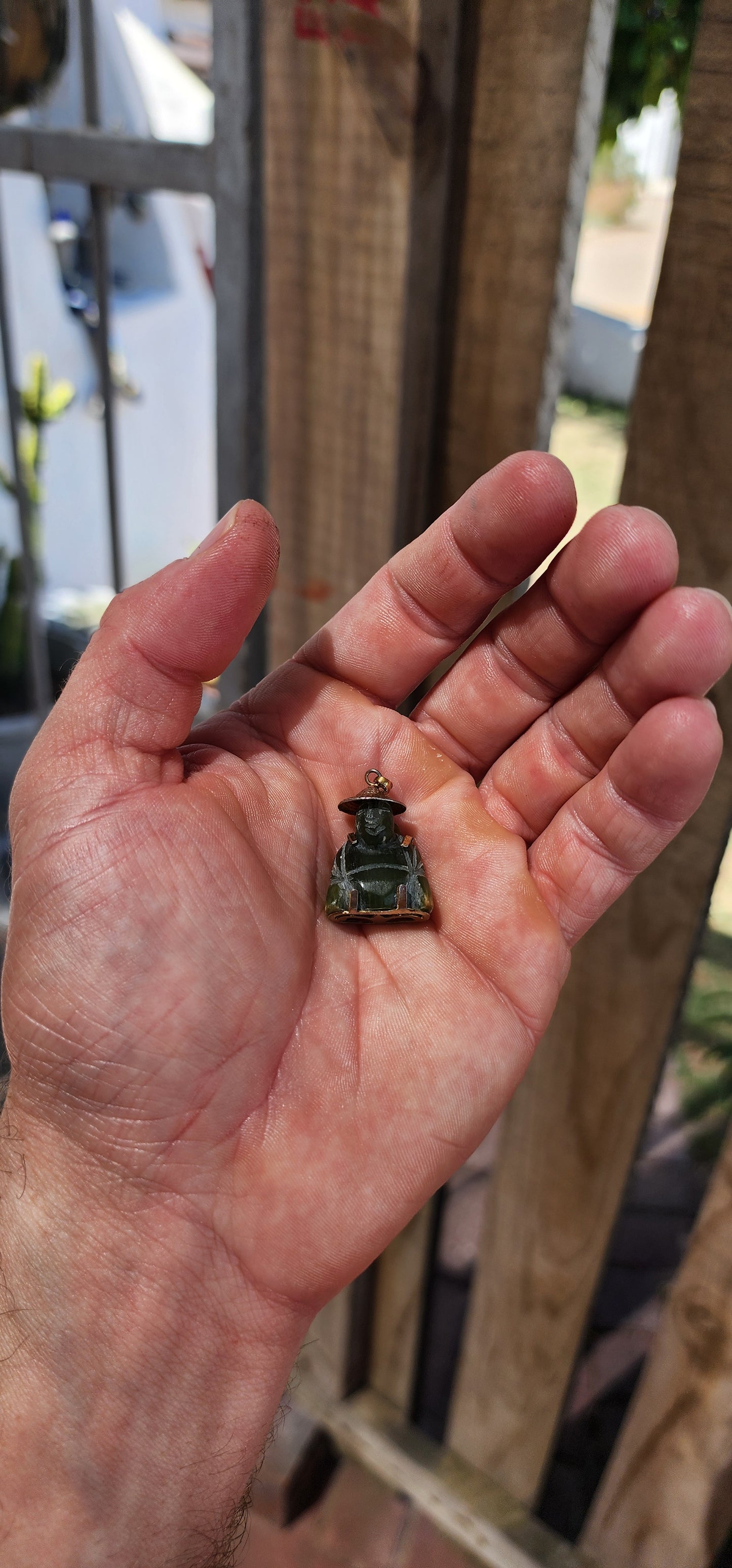 A delightful miniature Buddha pendant, carved from rich nephrite spinach jade and dating to the 1980s. Small in scale but big in character, this charming little figure is full of old-world symbolism.