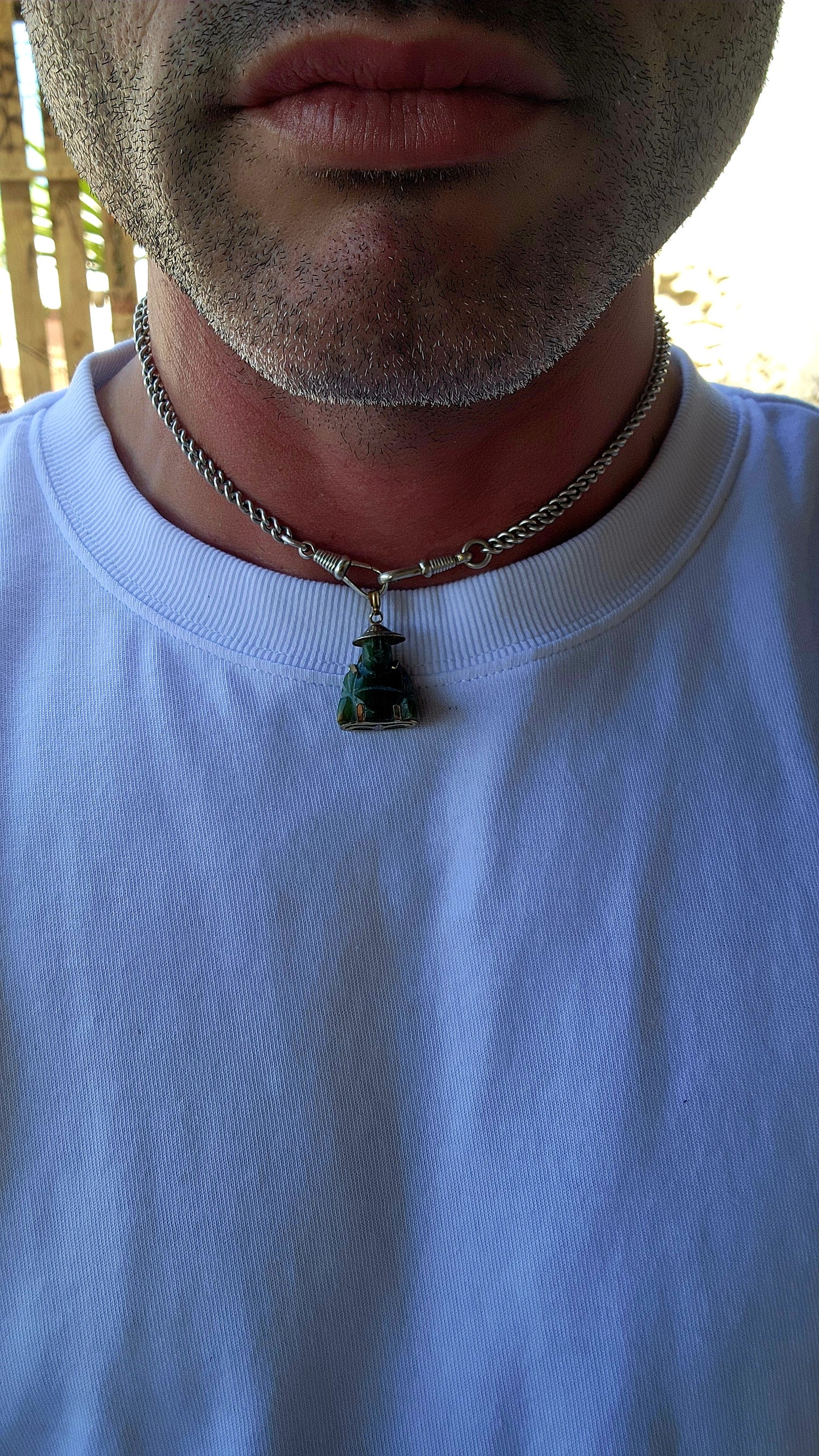A delightful miniature Buddha pendant, carved from rich nephrite spinach jade and dating to the 1980s. Small in scale but big in character, this charming little figure is full of old-world symbolism.