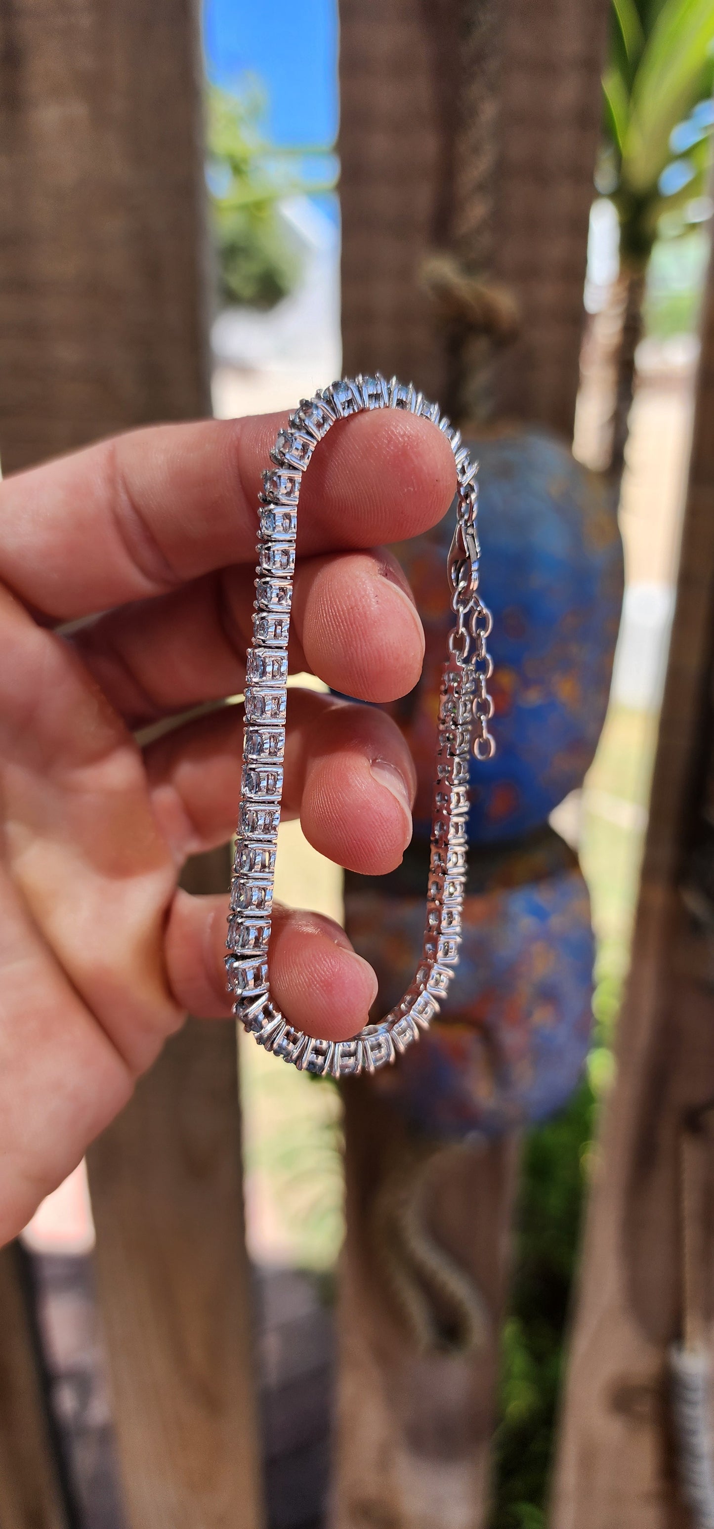 Effortlessly refined with a fresh, luminous glow, this classic tennis bracelet is crafted in polished sterling silver and set with a continuous line of sparkling sky blue topaz gemstones.