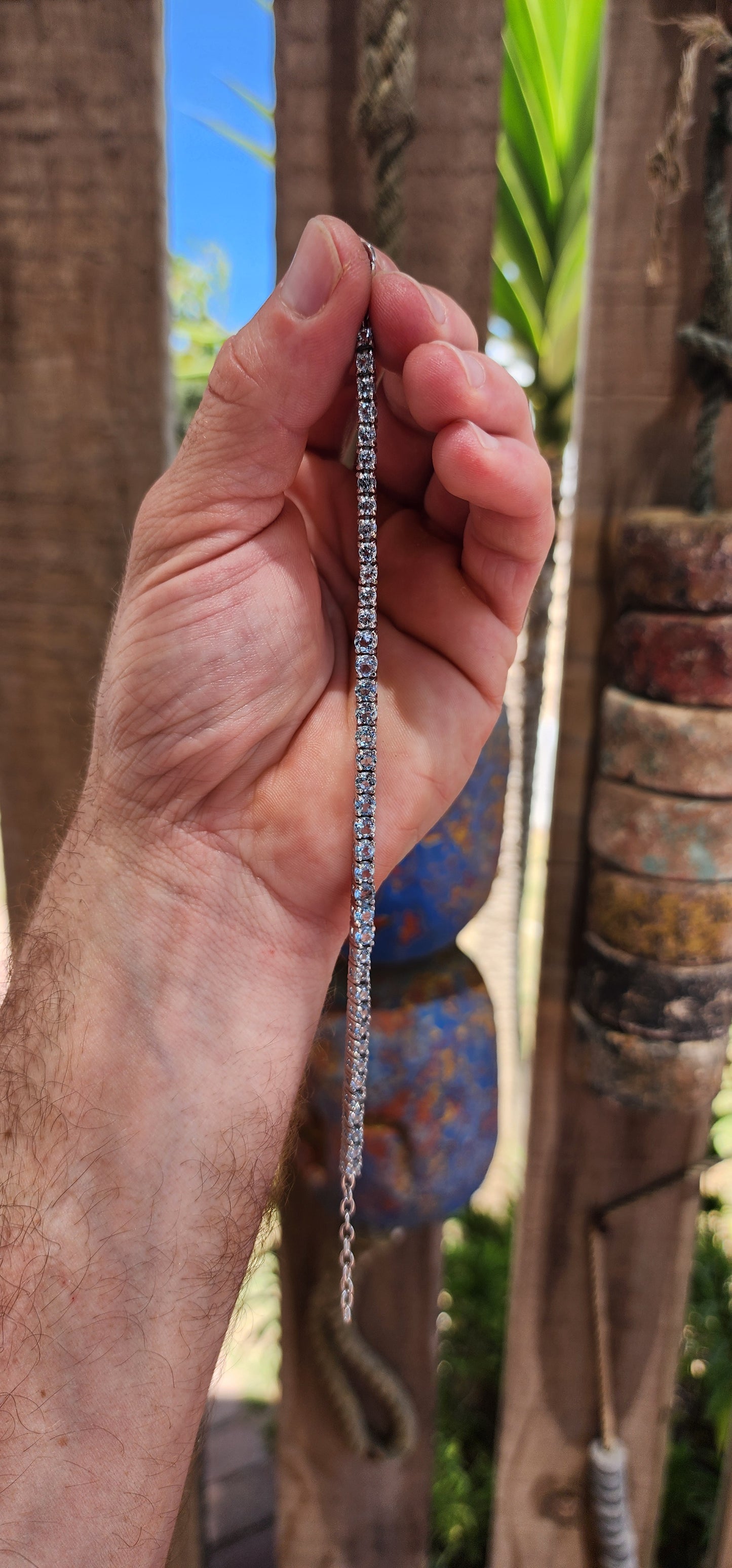 Effortlessly refined with a fresh, luminous glow, this classic tennis bracelet is crafted in polished sterling silver and set with a continuous line of sparkling sky blue topaz gemstones.