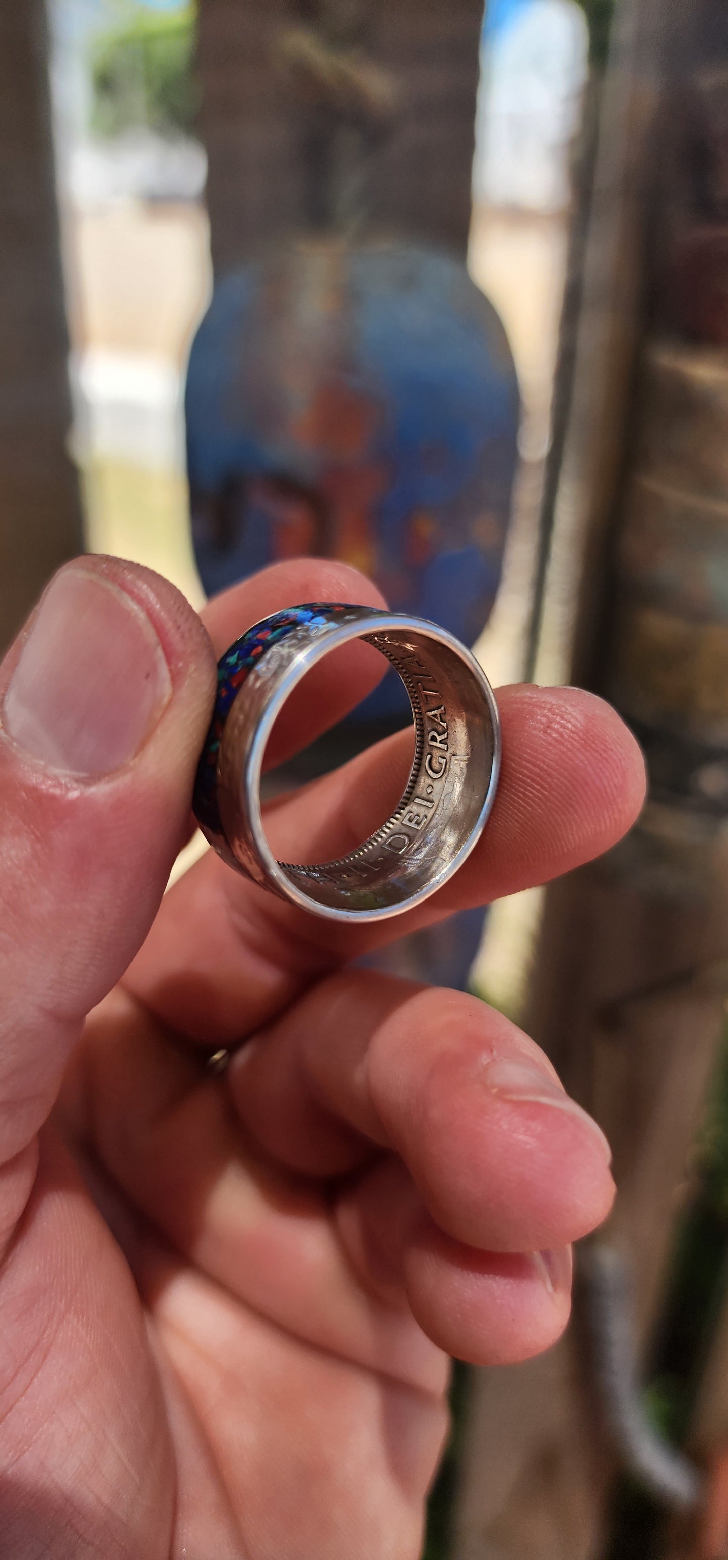 An artisan-made, one-of-a-kind statement ring crafted from an authentic Queen Elizabeth II Half Crown nickel coin — turning historical currency into rugged, wearable art.