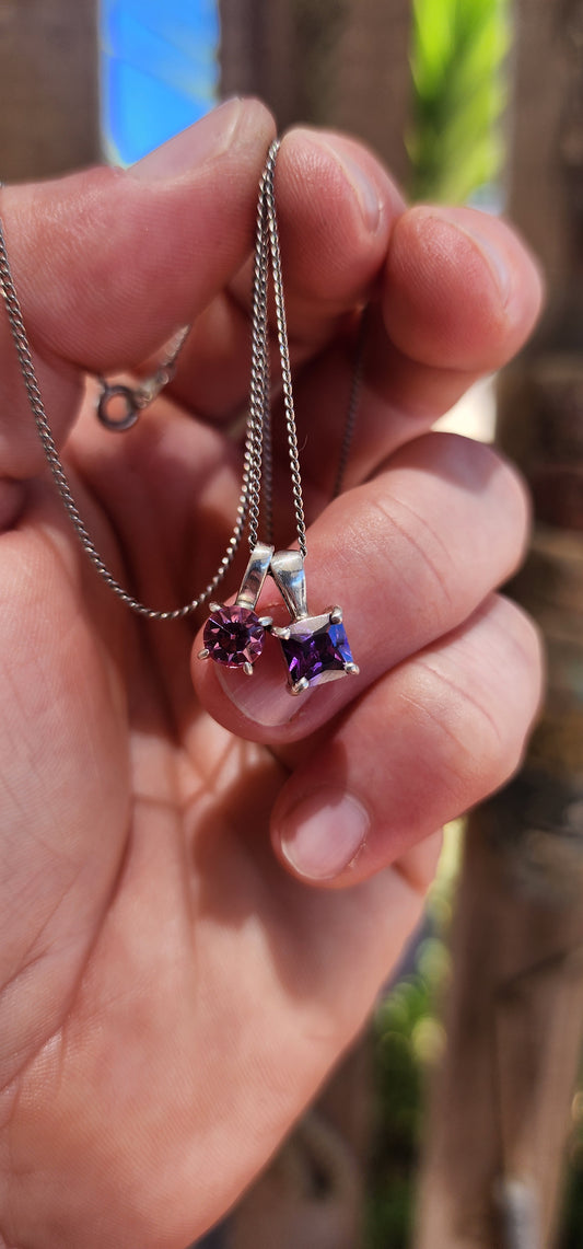 Double the charm, double the sparkle! This playful little beauty features two minimalist sterling silver pendants suspended together on a fine sterling silver chain.