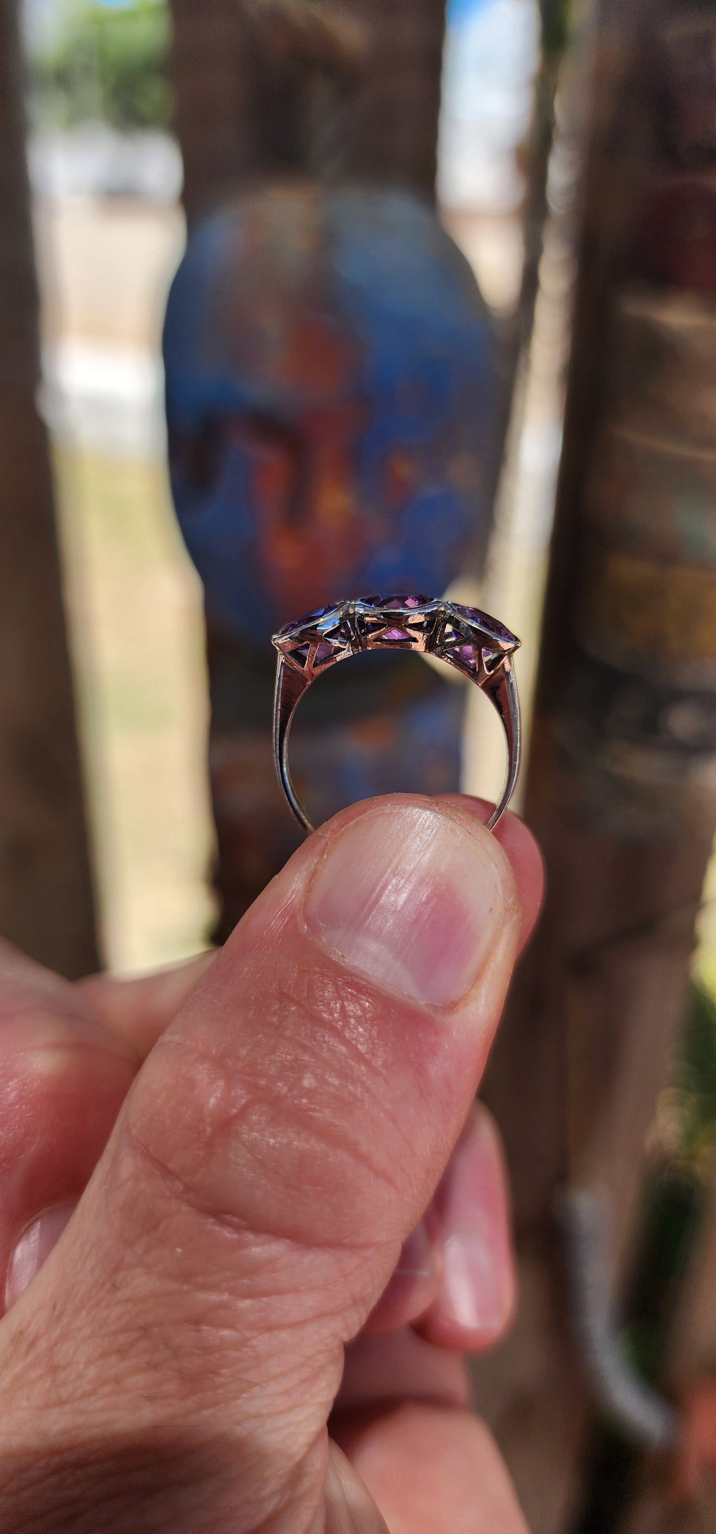 This sterling silver trilogy ring is a dreamy celebration of amethyst magic, set with three round faceted amethyst gemstones that glow in juicy shades of violet, plum and royal purple.
