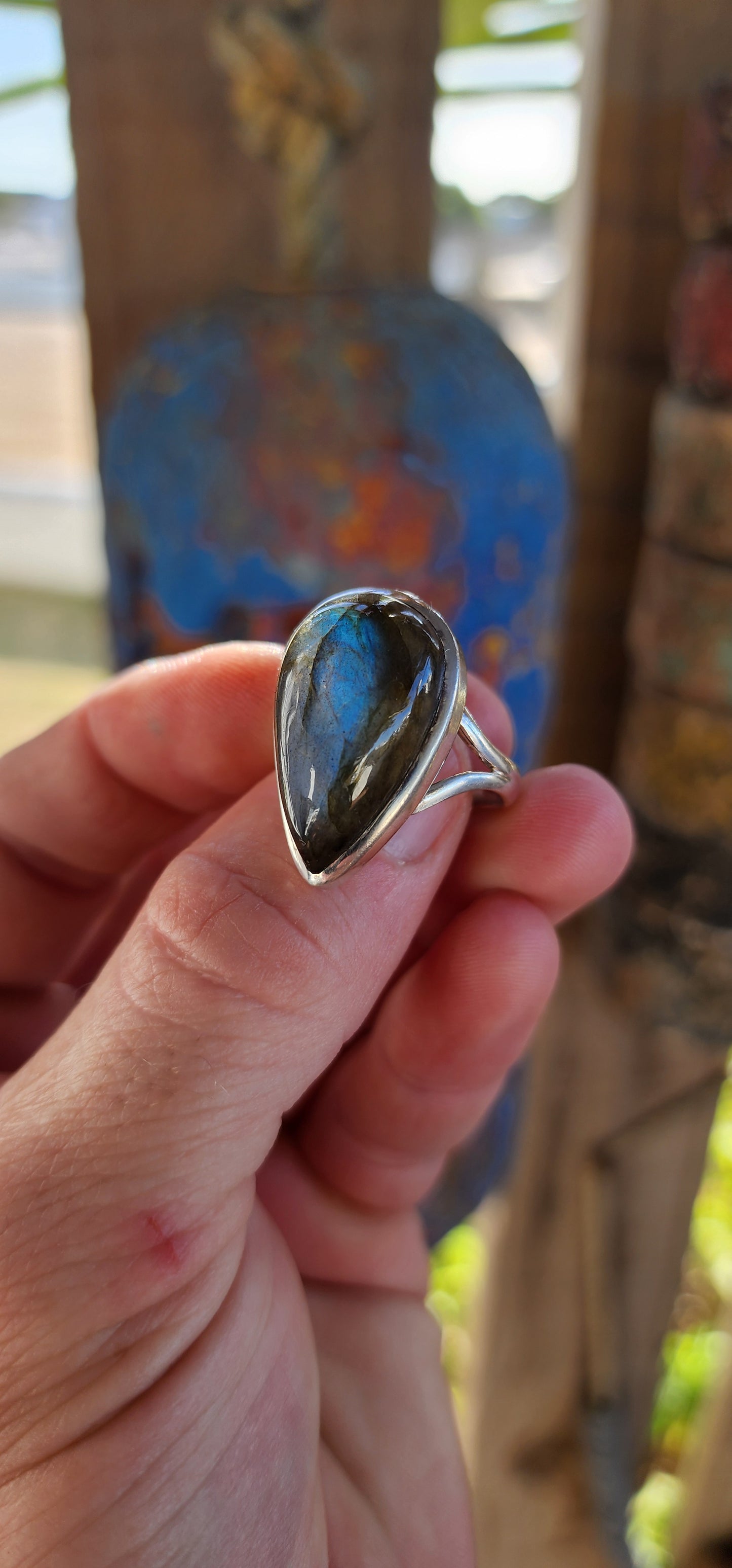A true mystic show-stopper — this enchanting, chunky artisan-made sterling silver cocktail ring features a generously sized pear-cut labradorite gemstone, bezel set in a sleek, sculptural frame that hugs the stone like liquid silver.