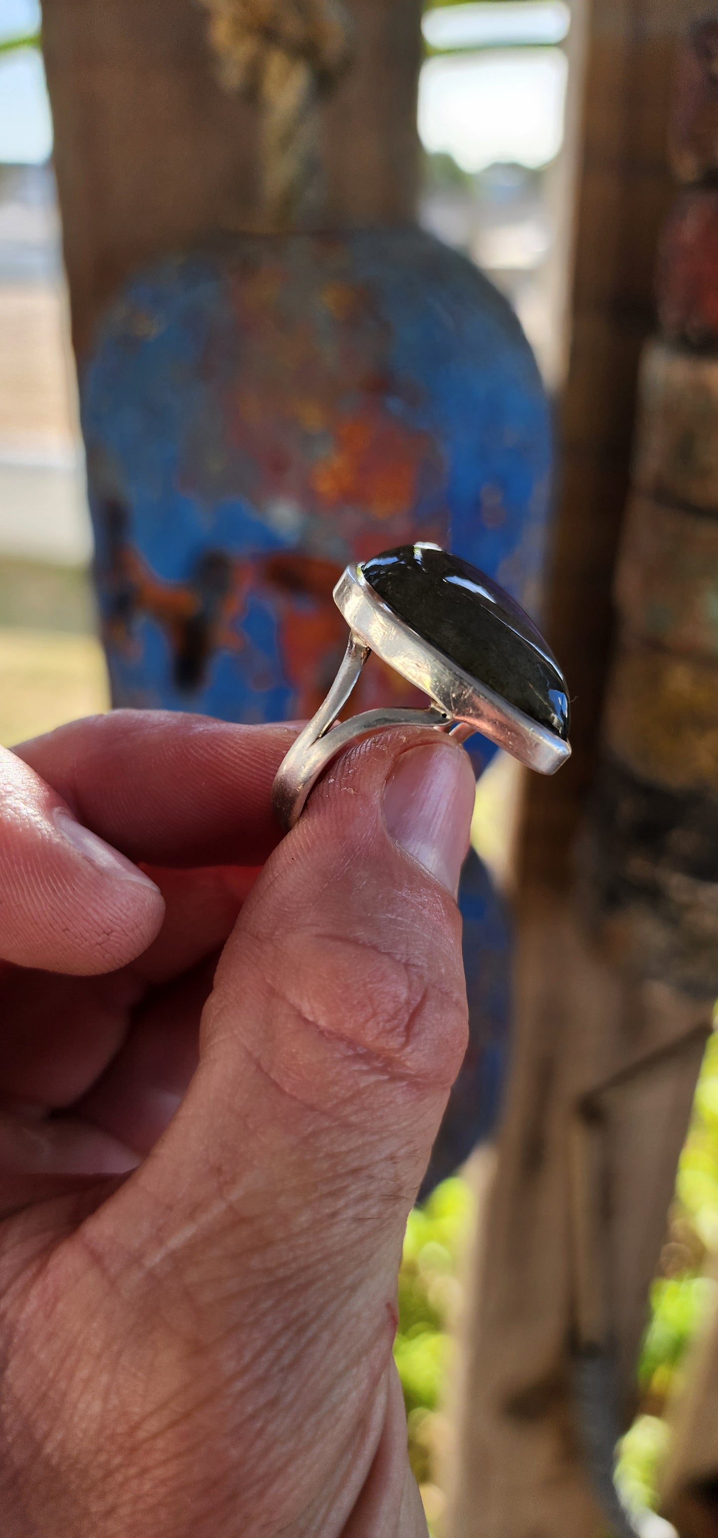 A true mystic show-stopper — this enchanting, chunky artisan-made sterling silver cocktail ring features a generously sized pear-cut labradorite gemstone, bezel set in a sleek, sculptural frame that hugs the stone like liquid silver.