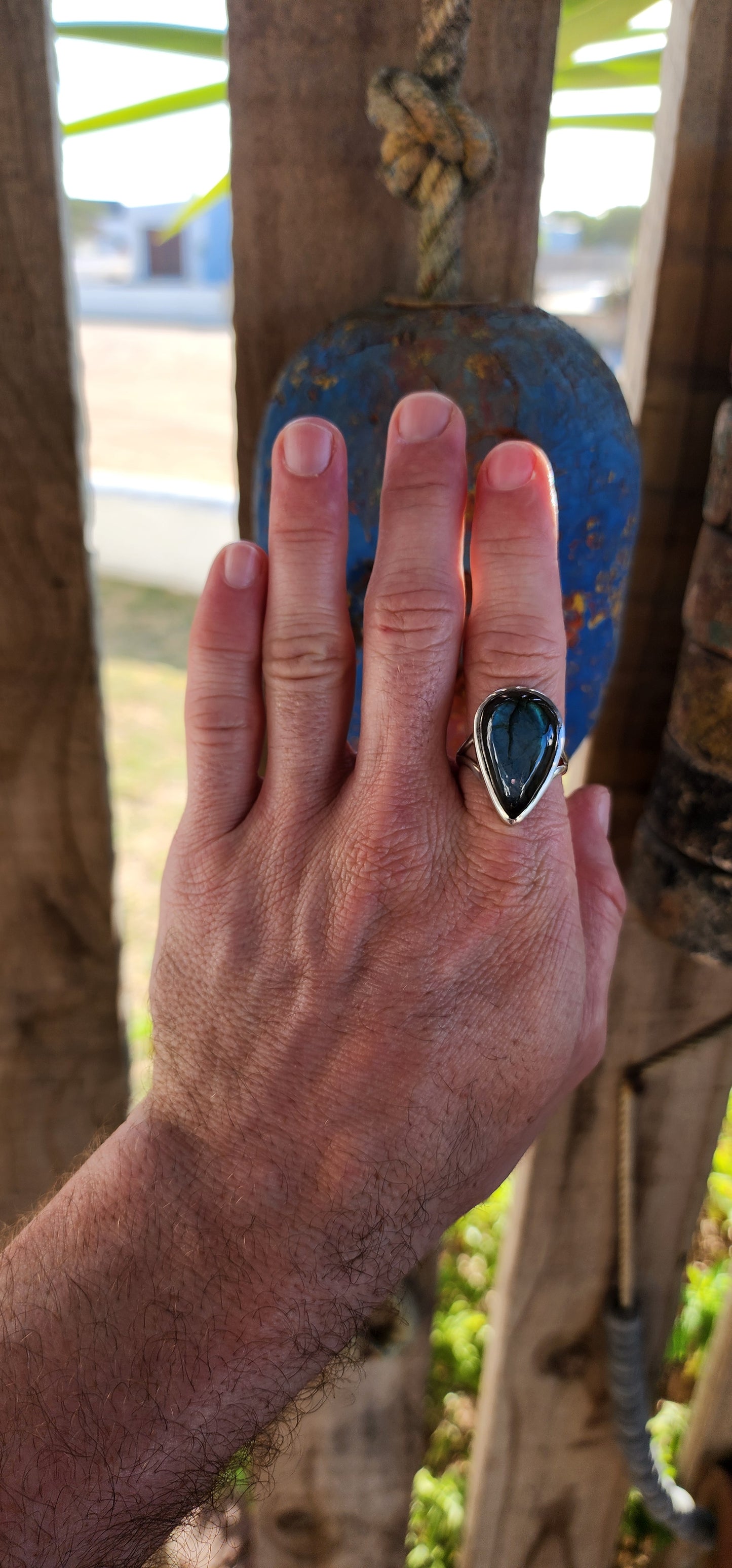 A true mystic show-stopper — this enchanting, chunky artisan-made sterling silver cocktail ring features a generously sized pear-cut labradorite gemstone, bezel set in a sleek, sculptural frame that hugs the stone like liquid silver.