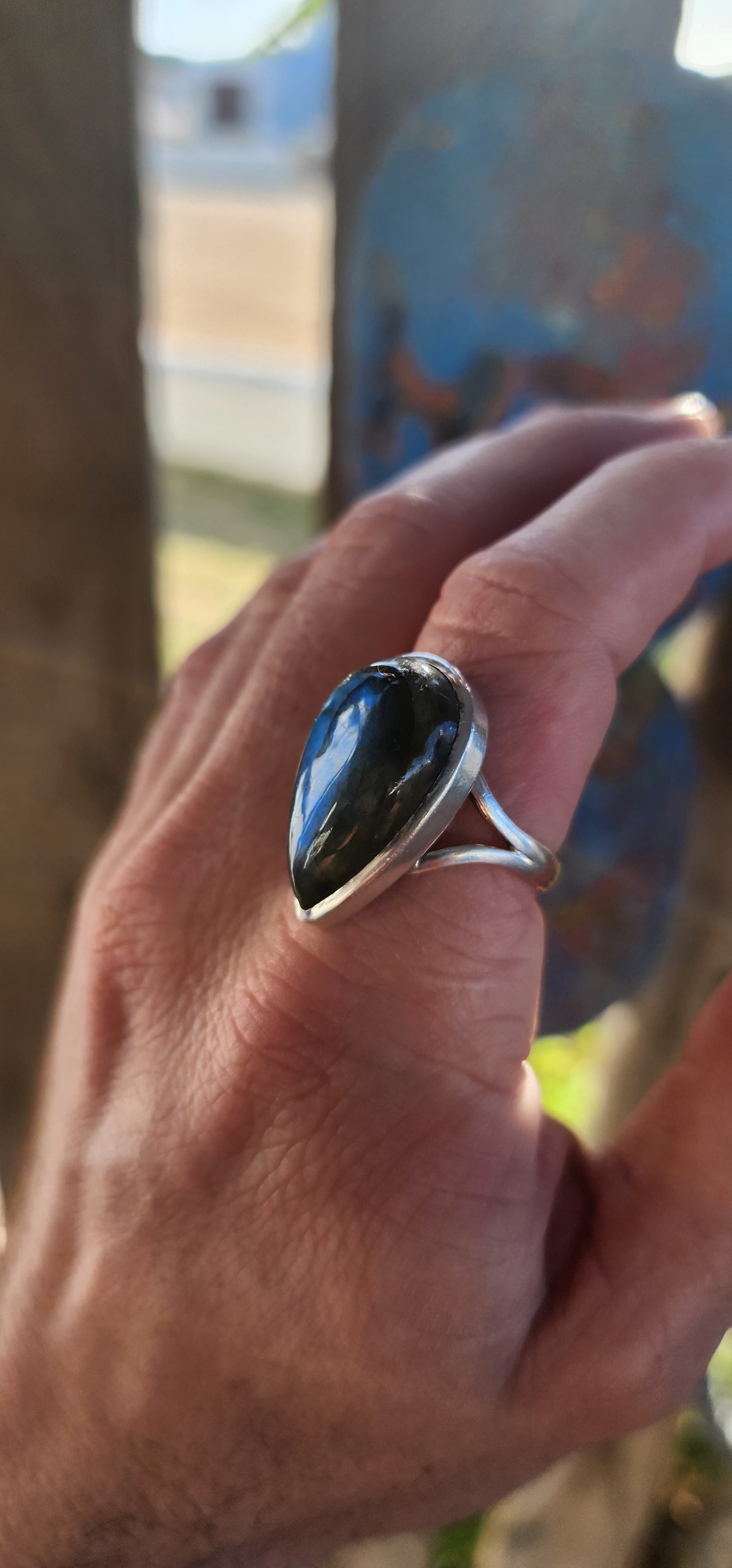 A true mystic show-stopper — this enchanting, chunky artisan-made sterling silver cocktail ring features a generously sized pear-cut labradorite gemstone, bezel set in a sleek, sculptural frame that hugs the stone like liquid silver.