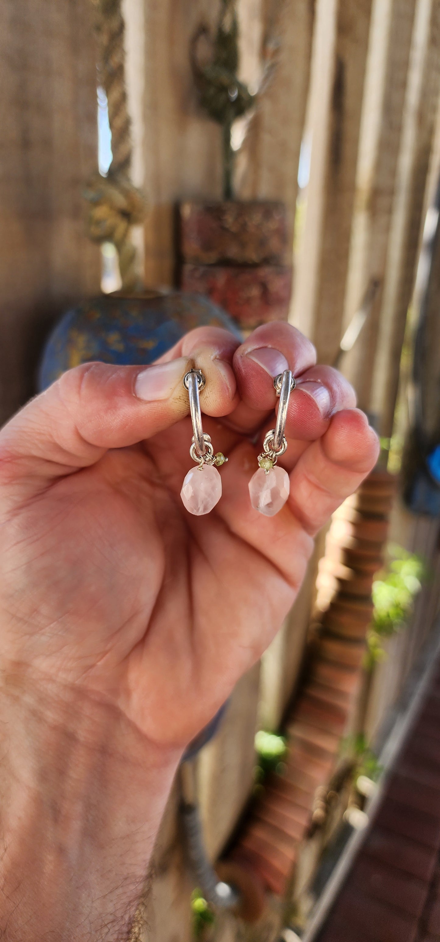 A gorgeous artisan-made pair of sterling silver half-hoop / huggie style earrings, designed with a clean modern silhouette and the sweetest little gemstone charm dangles.