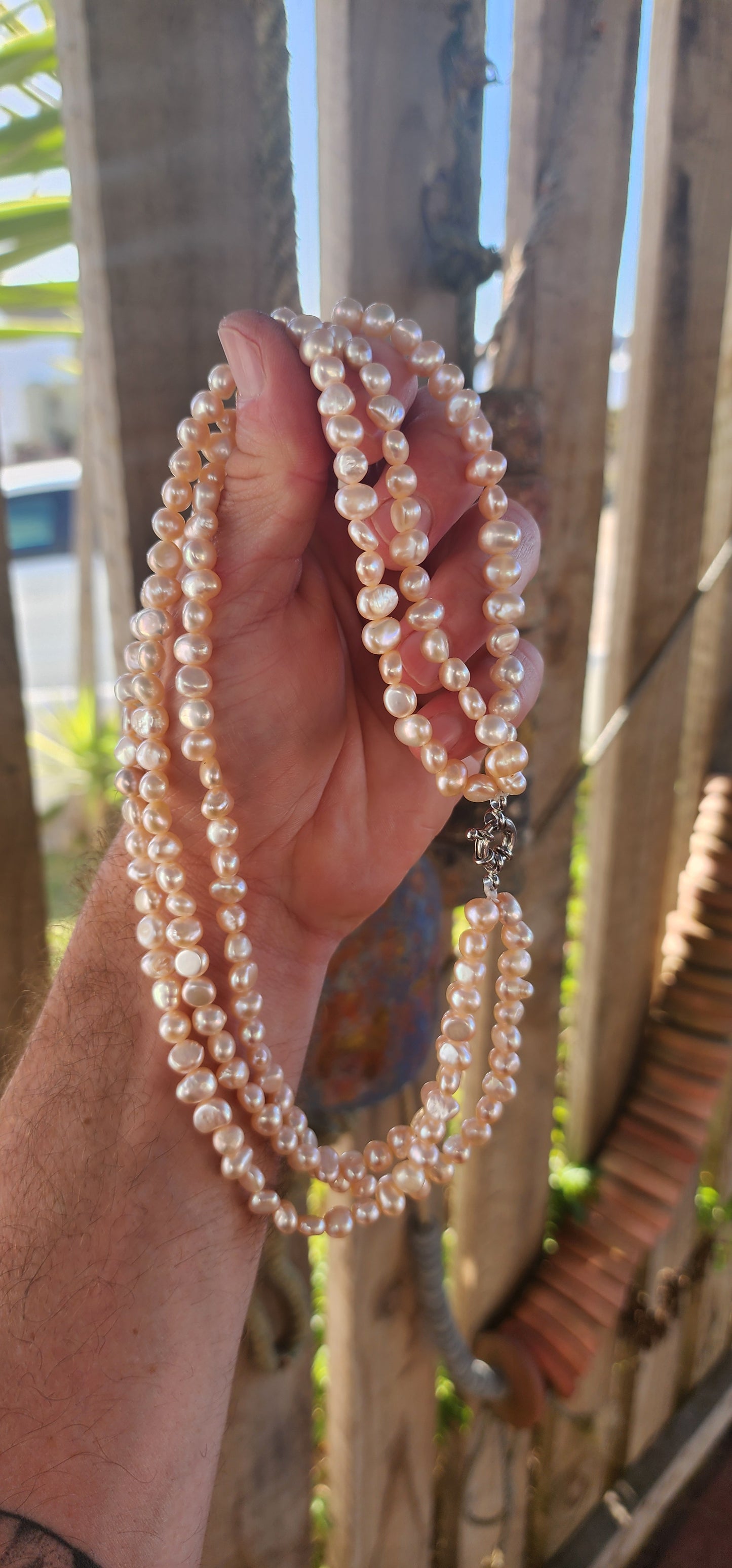 Elegant and seriously luxurious — this handmade three-strand freshwater pearl necklace is a classical beauty with a modern edge.