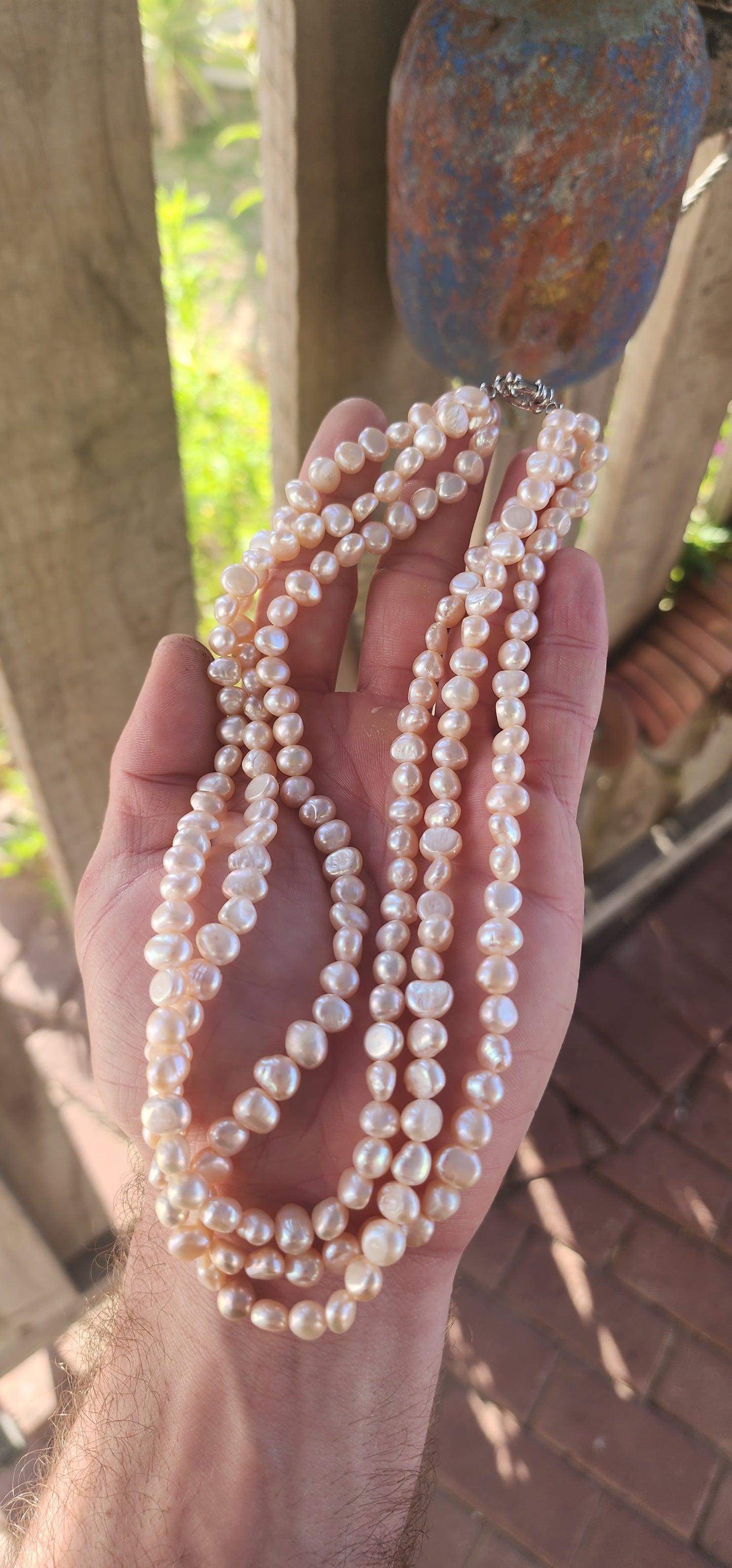 Elegant and seriously luxurious — this handmade three-strand freshwater pearl necklace is a classical beauty with a modern edge.