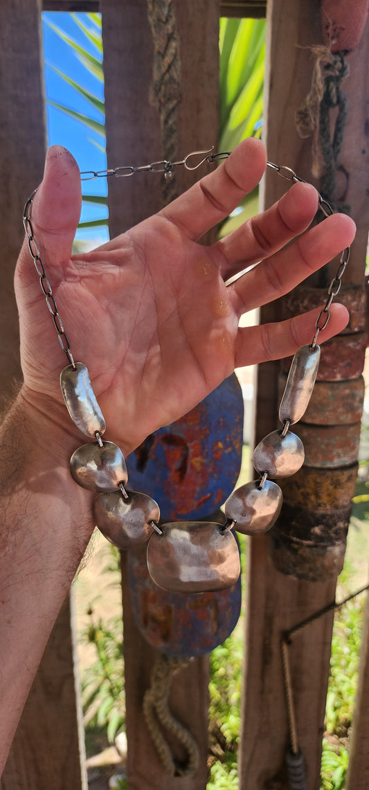 This powerful statement necklace carries the soul of traditional tribal adornment fused with sculptural modernist design.