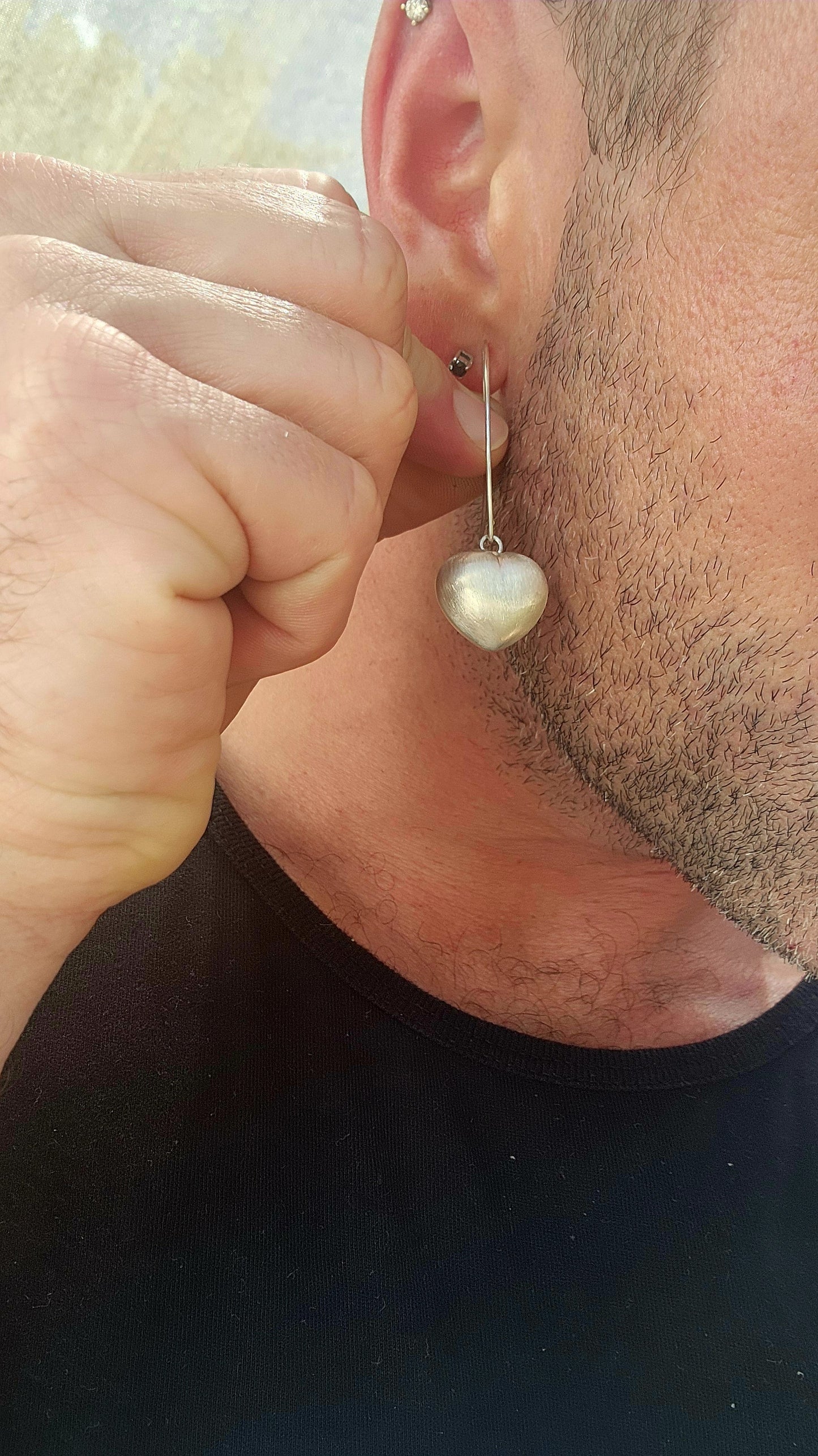 Sweet, but with presence. These sterling silver dangle drop earrings feature beautifully generous-sized puffed heart charms suspended from sleek shepherd hook wires.