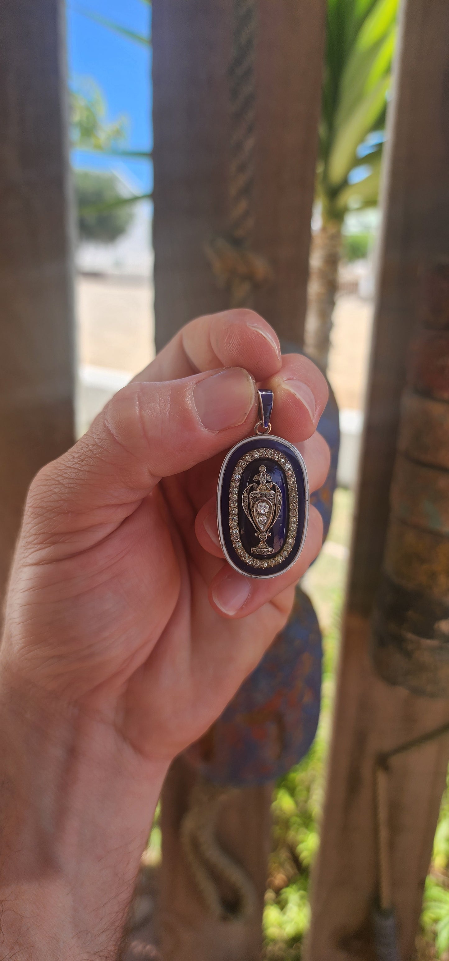 An exceptionally rare early 19th-century Georgian mourning pendant, crafted in sterling silver and lavishly decorated with royal blue and white enamel, glittering paste stones, and natural diamonds.
