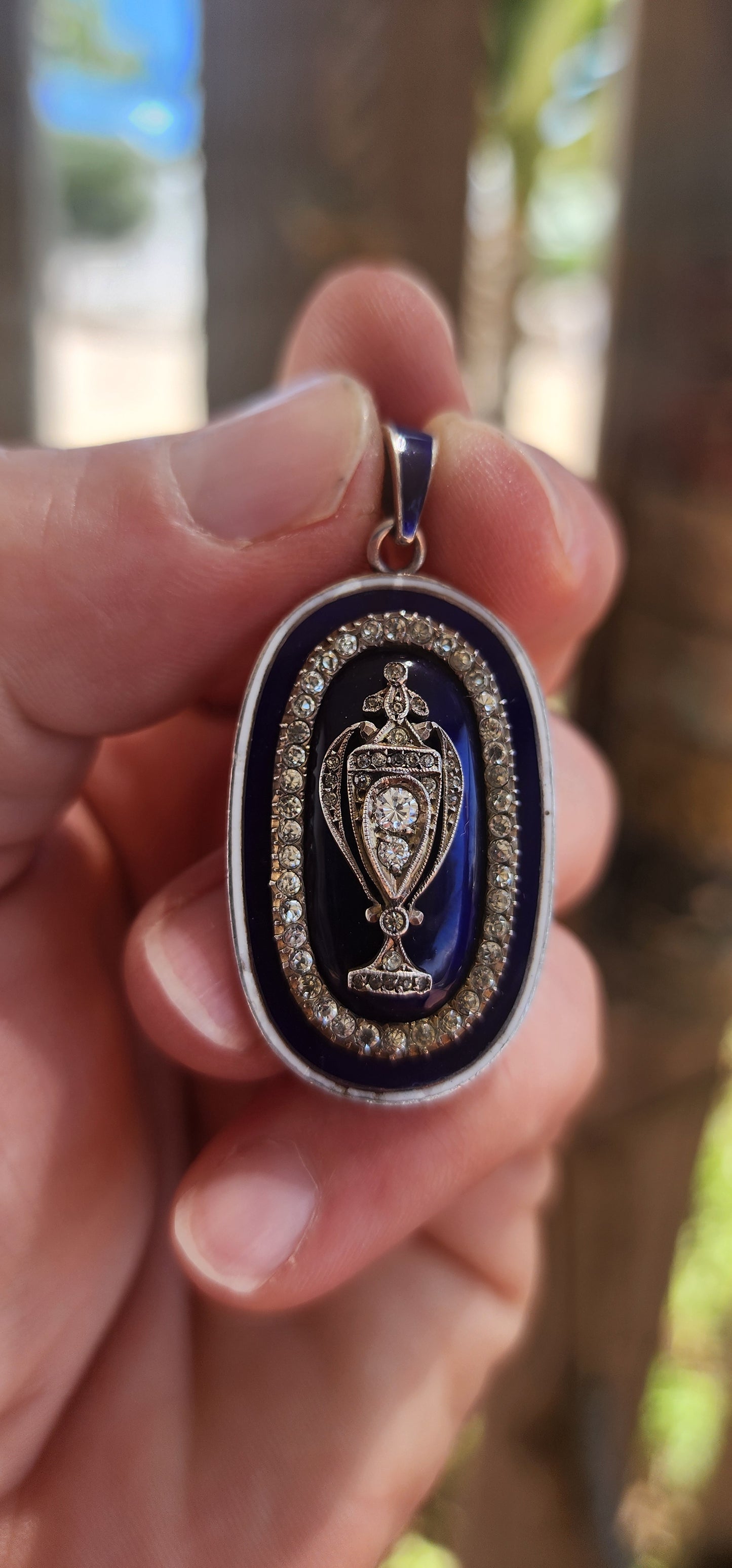 An exceptionally rare early 19th-century Georgian mourning pendant, crafted in sterling silver and lavishly decorated with royal blue and white enamel, glittering paste stones, and natural diamonds.