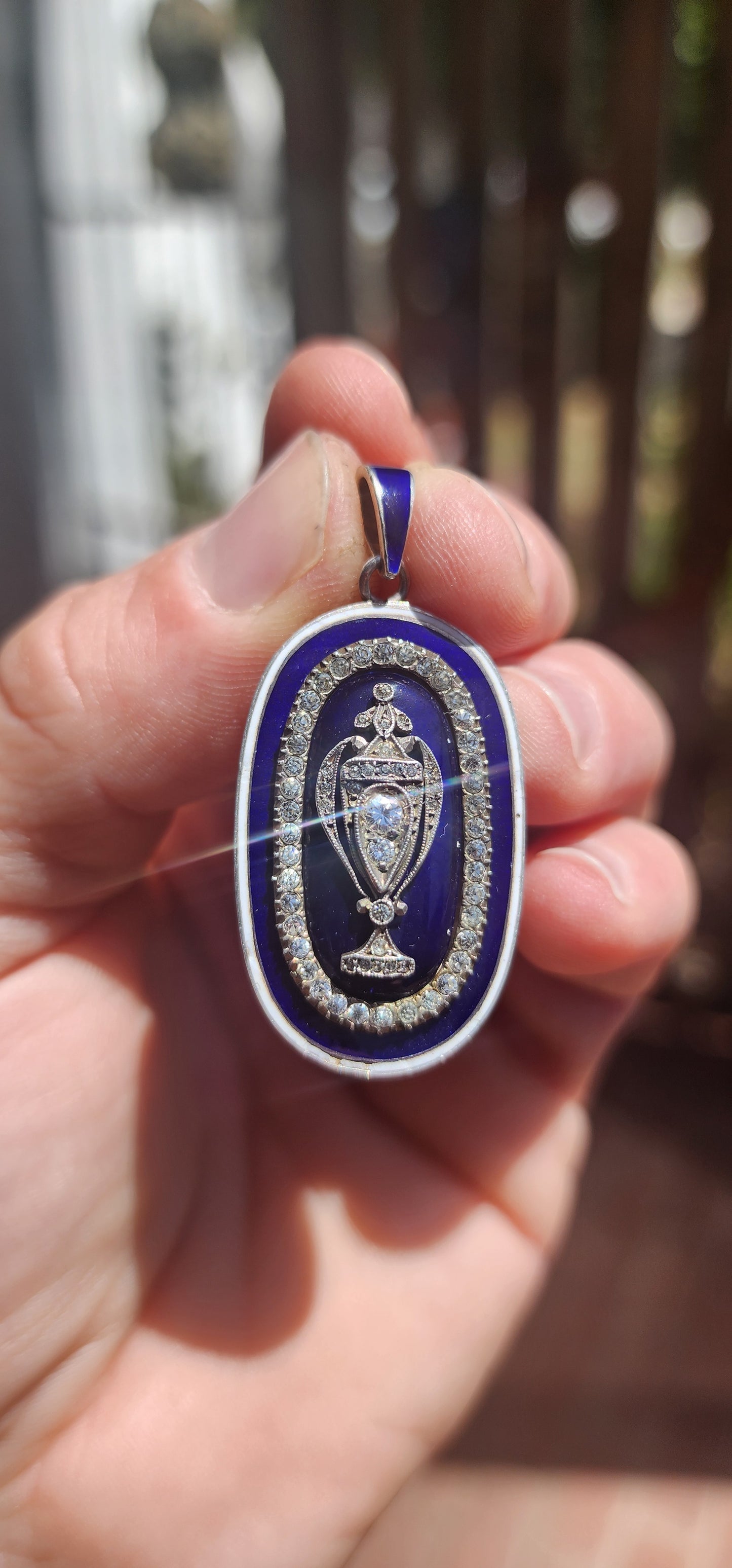 An exceptionally rare early 19th-century Georgian mourning pendant, crafted in sterling silver and lavishly decorated with royal blue and white enamel, glittering paste stones, and natural diamonds.