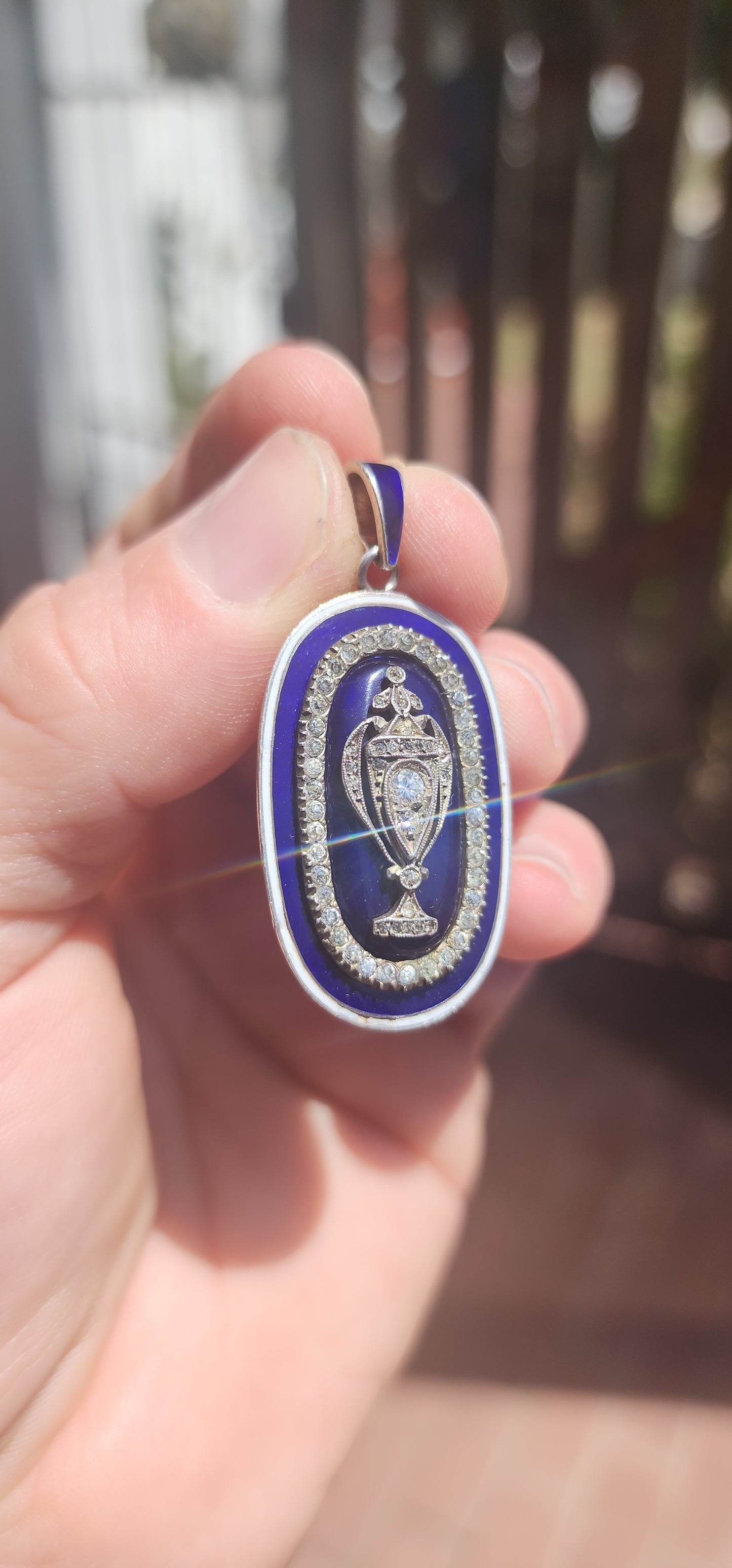An exceptionally rare early 19th-century Georgian mourning pendant, crafted in sterling silver and lavishly decorated with royal blue and white enamel, glittering paste stones, and natural diamonds.