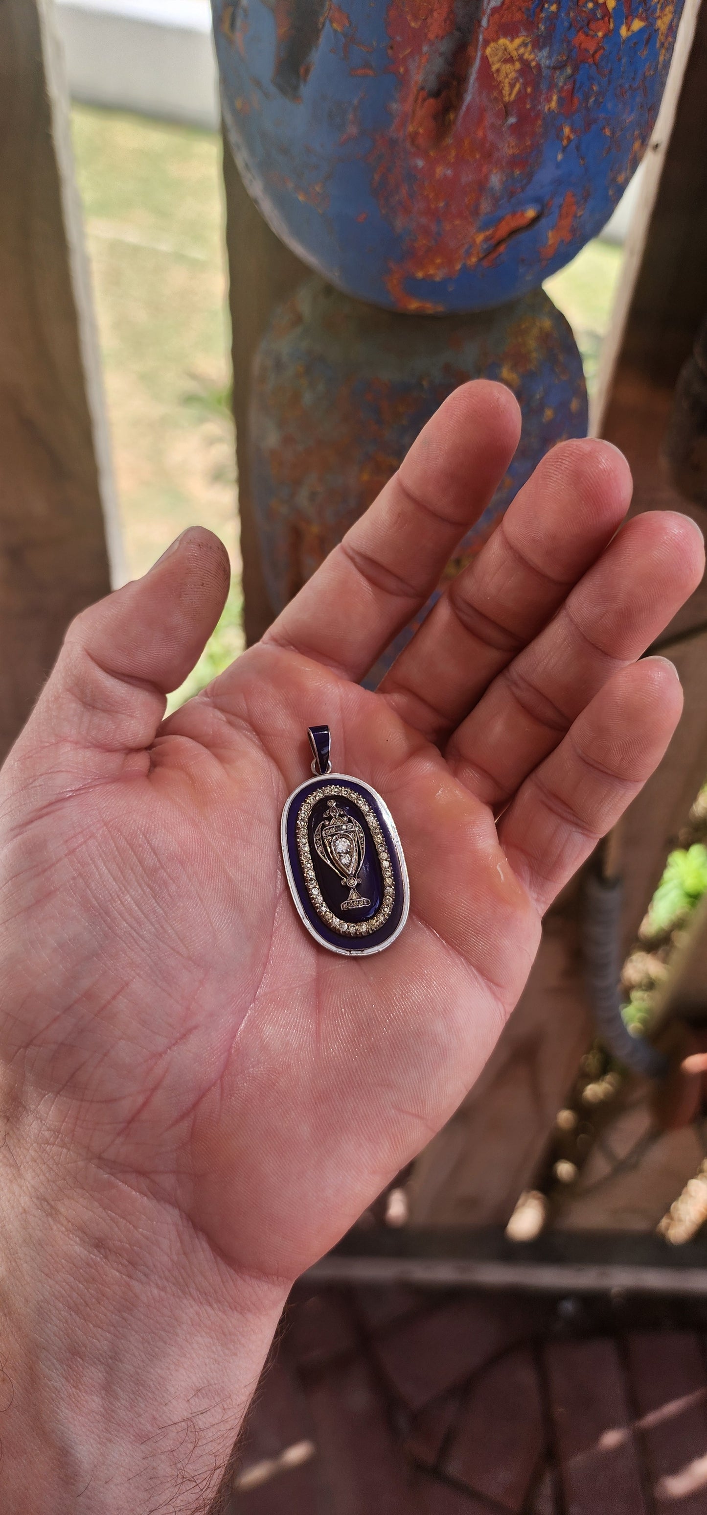 An exceptionally rare early 19th-century Georgian mourning pendant, crafted in sterling silver and lavishly decorated with royal blue and white enamel, glittering paste stones, and natural diamonds.