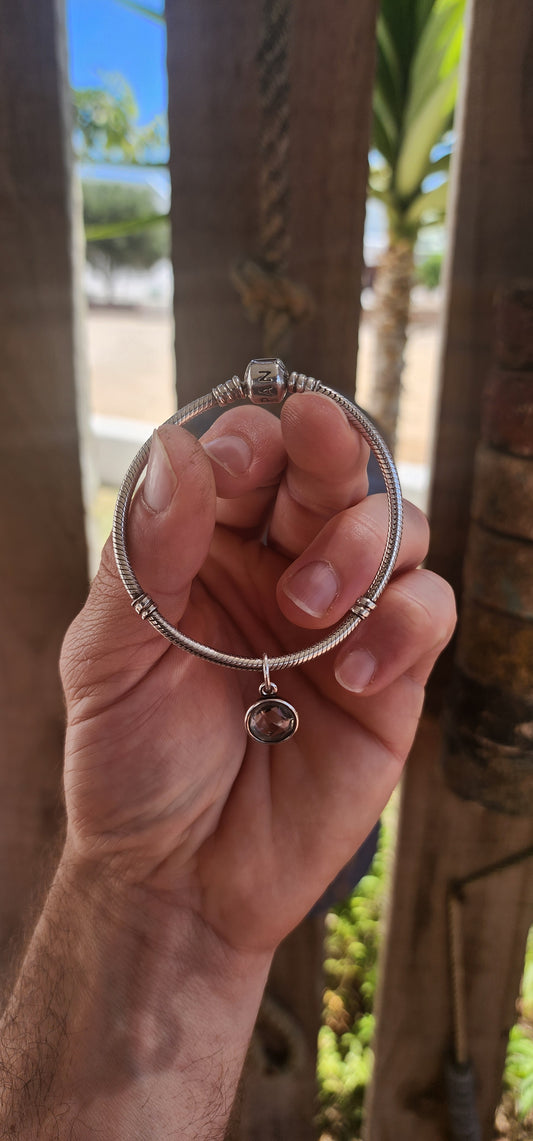 A beautifully wearable Pandora sterling silver snake chain bracelet, paired with a luminous prasiolite (green amethyst) dangle charm.