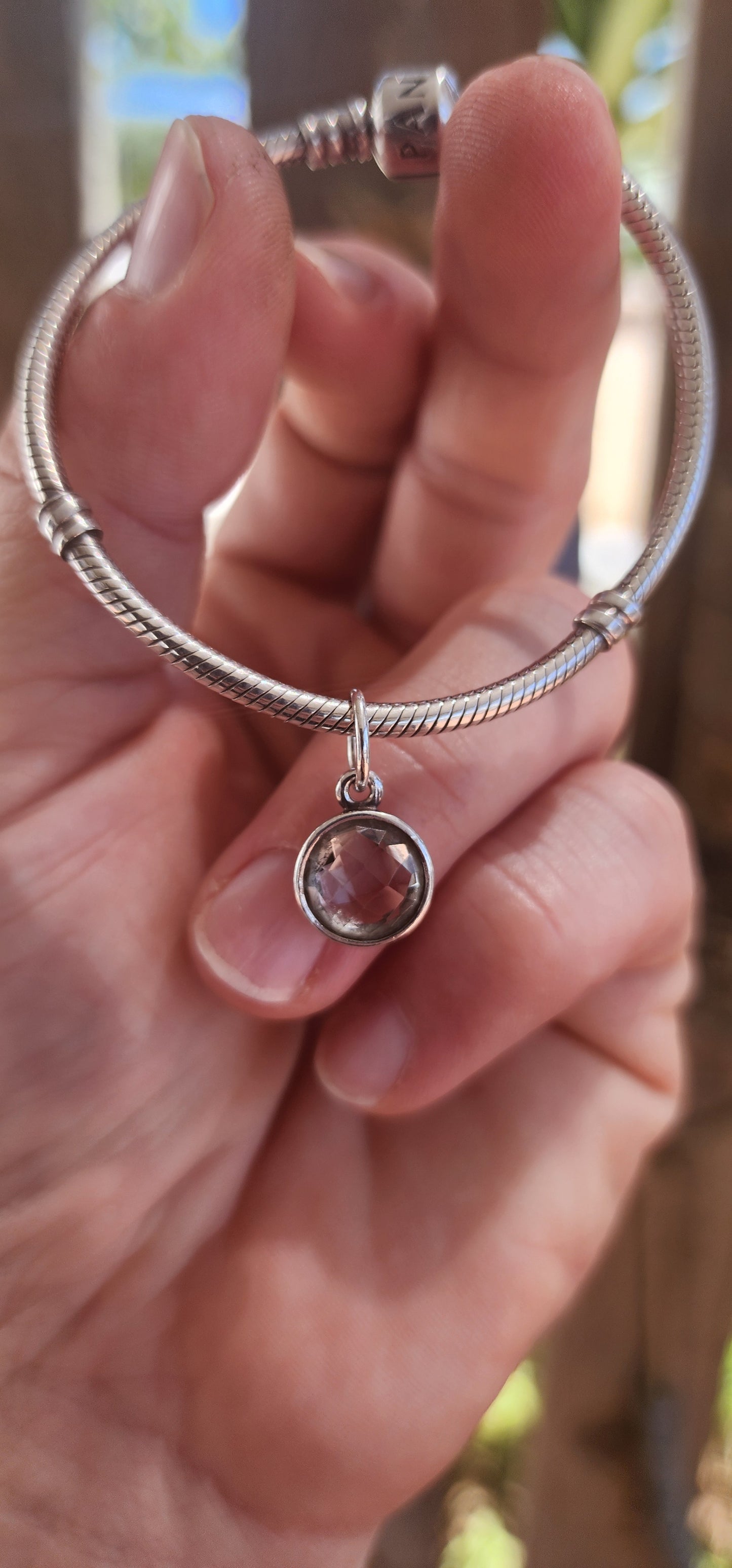 A beautifully wearable Pandora sterling silver snake chain bracelet, paired with a luminous prasiolite (green amethyst) dangle charm.