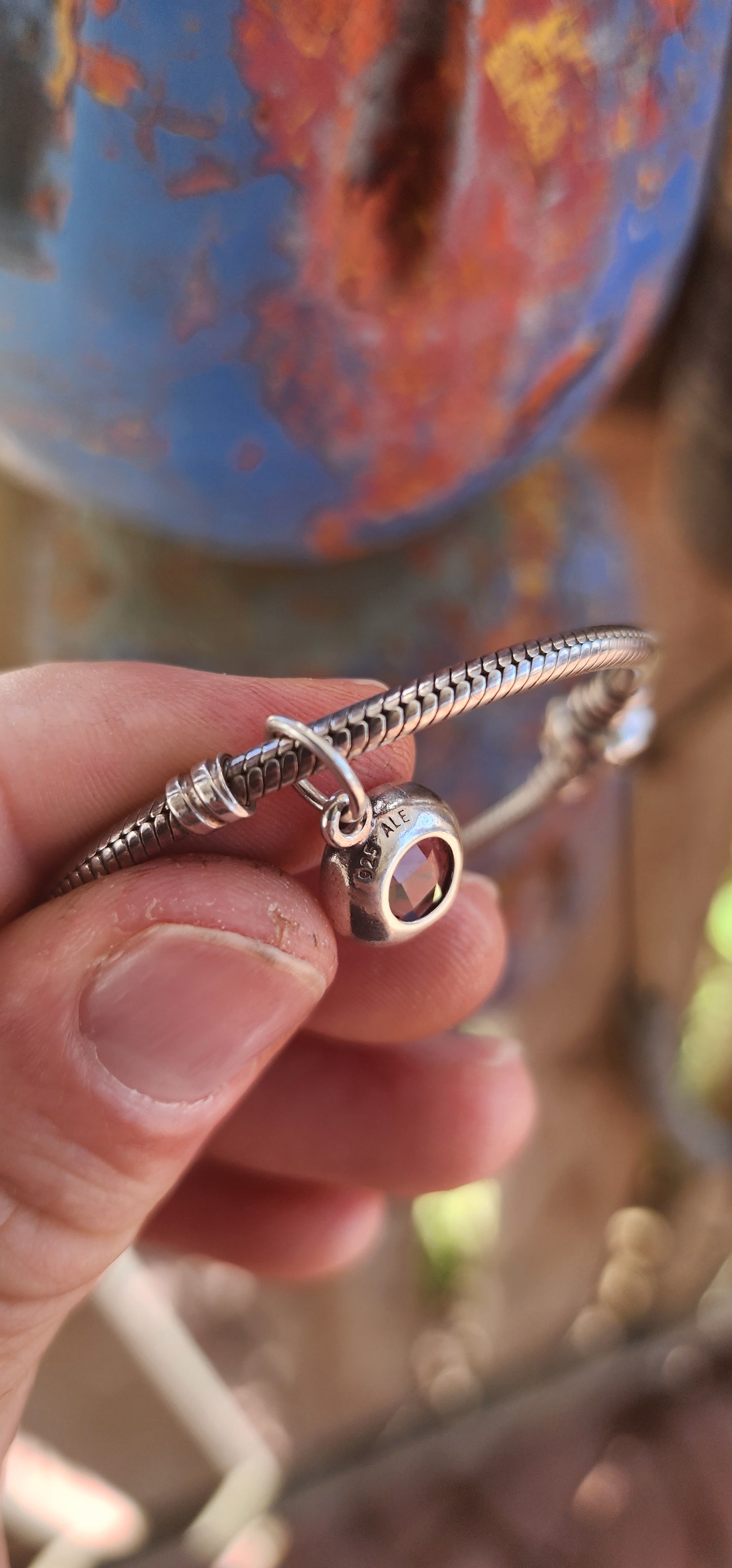 A beautifully wearable Pandora sterling silver snake chain bracelet, paired with a luminous prasiolite (green amethyst) dangle charm.