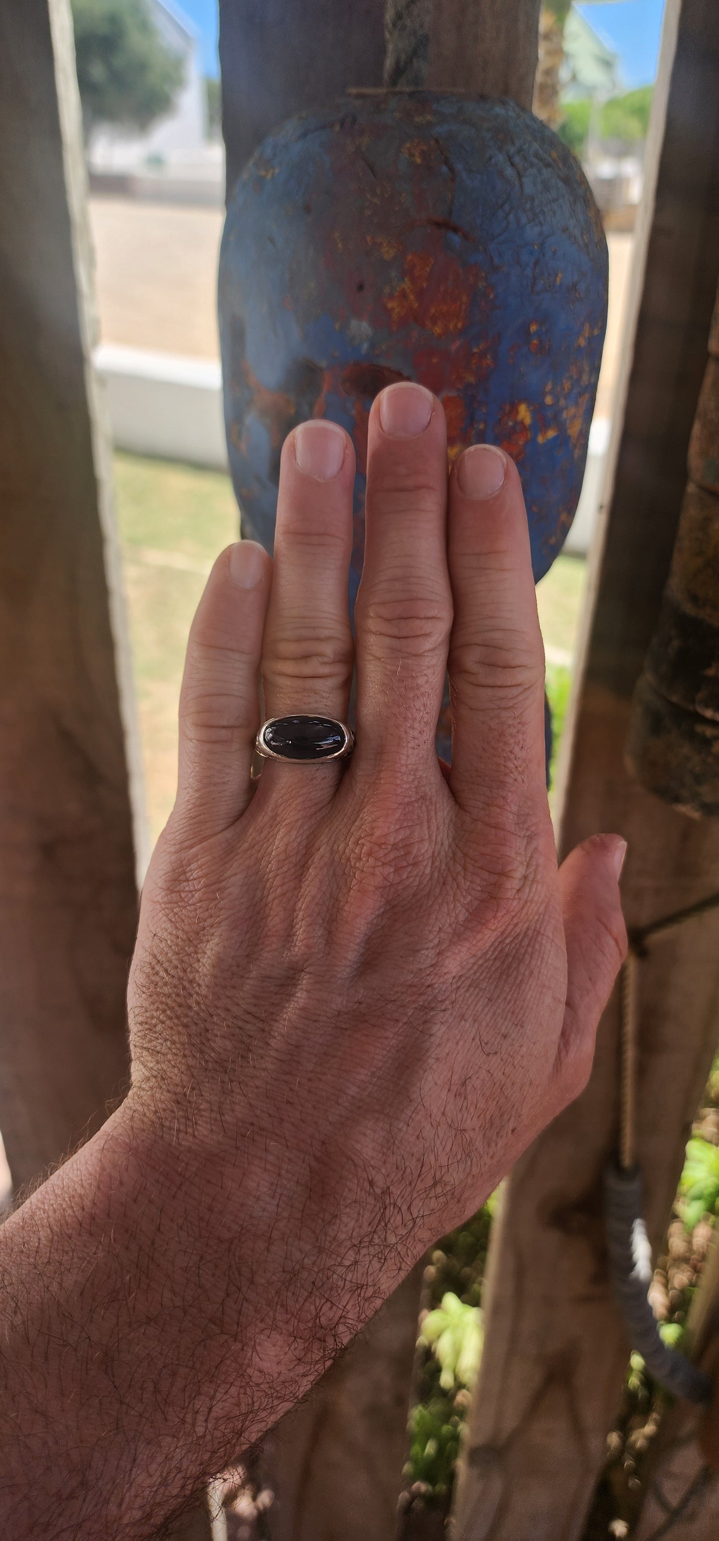 A striking unisex sterling silver dress ring showcasing a generously sized oval blue sapphire cabochon as its commanding centrepiece