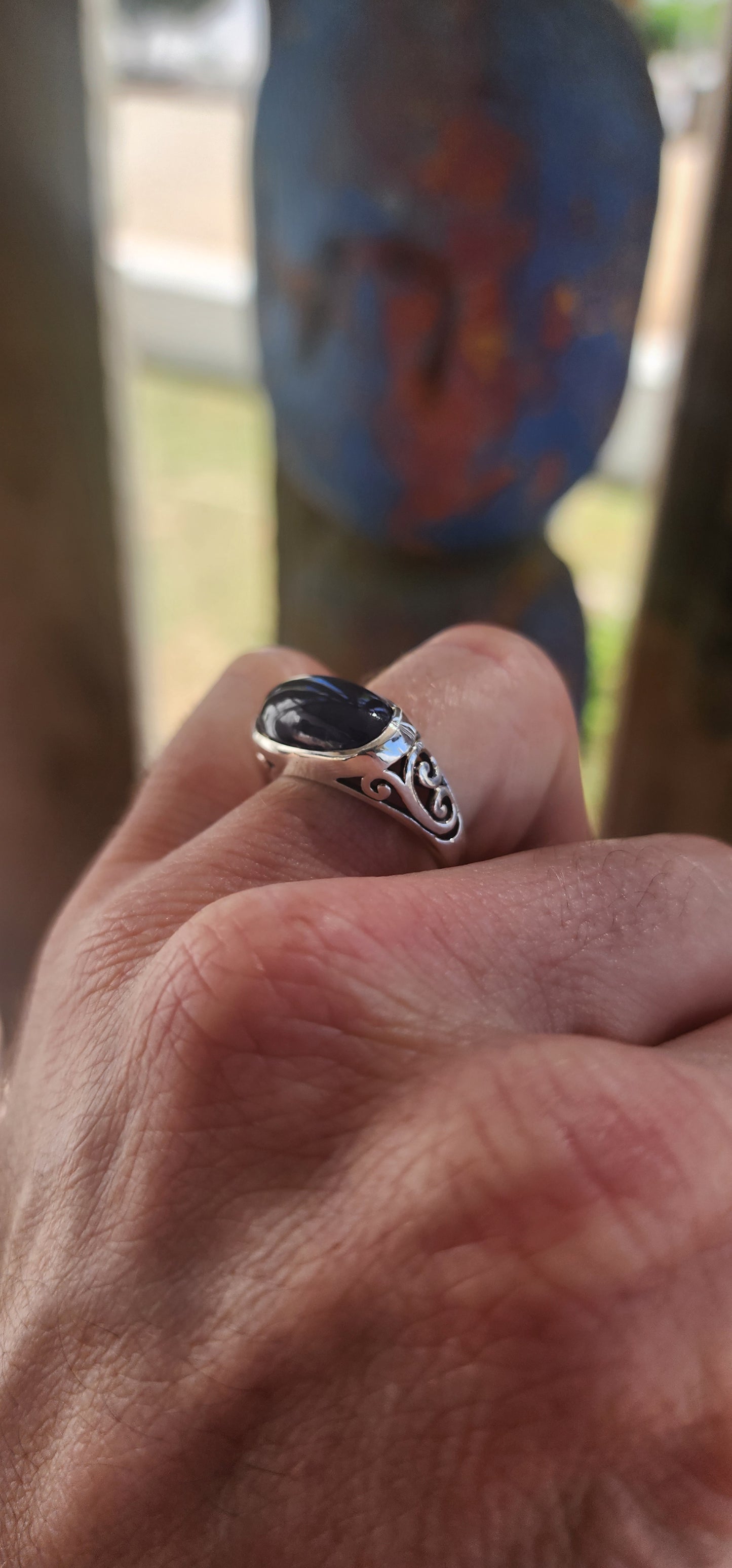 A striking unisex sterling silver dress ring showcasing a generously sized oval blue sapphire cabochon as its commanding centrepiece