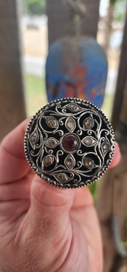 This extraordinary round brooch is crafted in 800-grade silver and represents traditional Javanese / Indonesian silversmithing, dating to the late Victorian period (late 1800s)