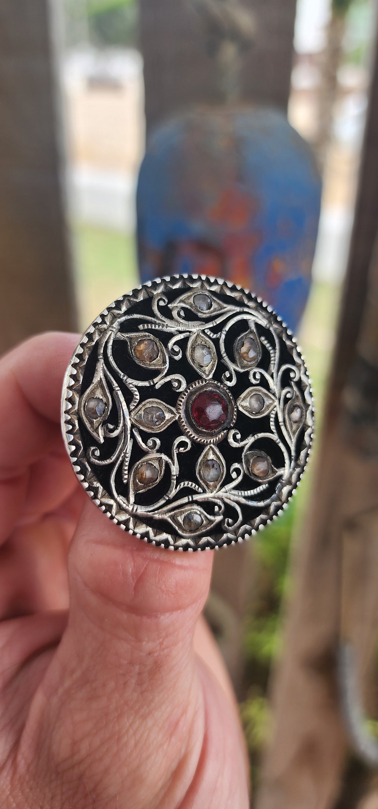 This extraordinary round brooch is crafted in 800-grade silver and represents traditional Javanese / Indonesian silversmithing, dating to the late Victorian period (late 1800s)