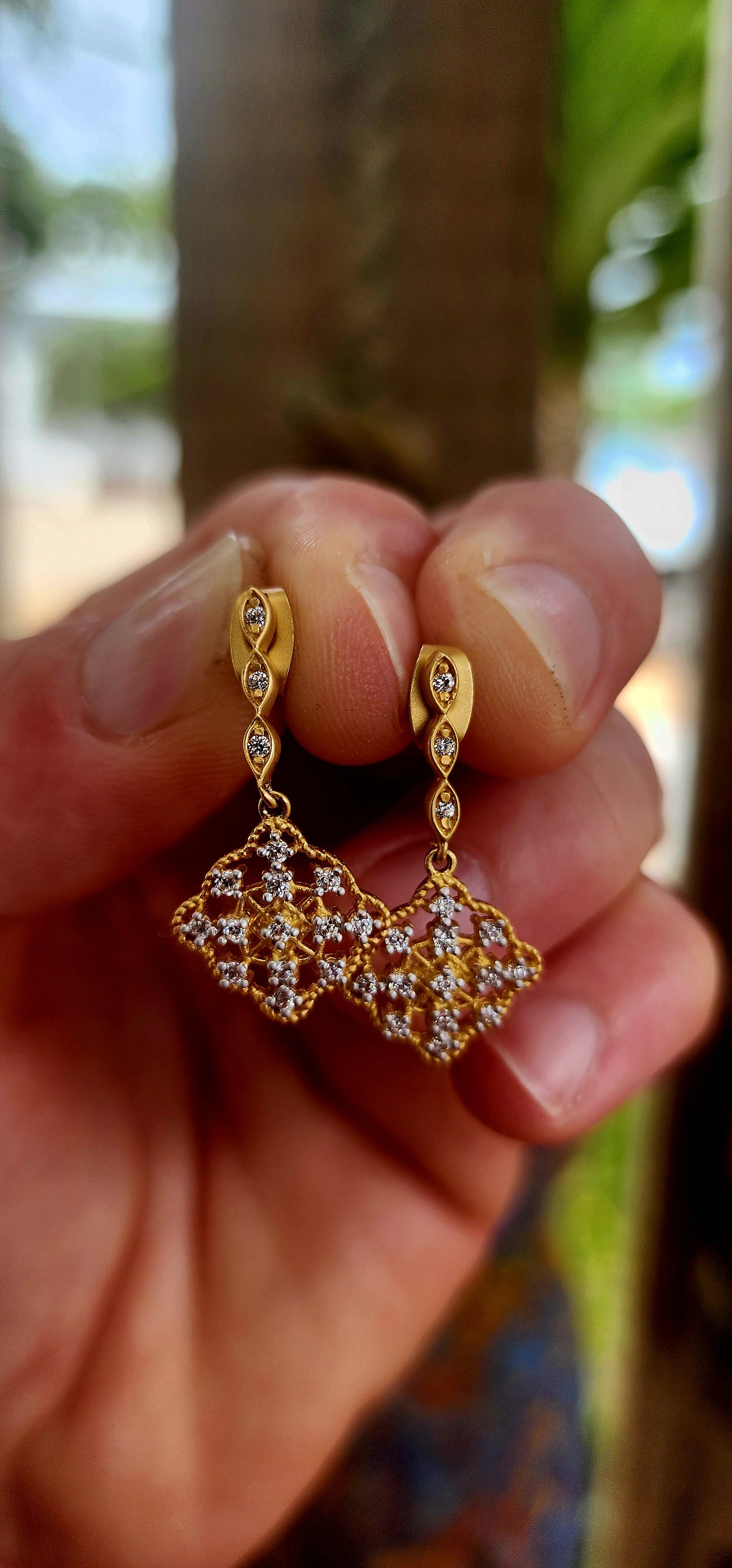 This beautiful pair of antique-revival drop earrings is crafted in sterling silver, finished with a soft matte yellow-gold plating that gives the piece a warm, understated glow reminiscent of true vintage/antique jewellery.