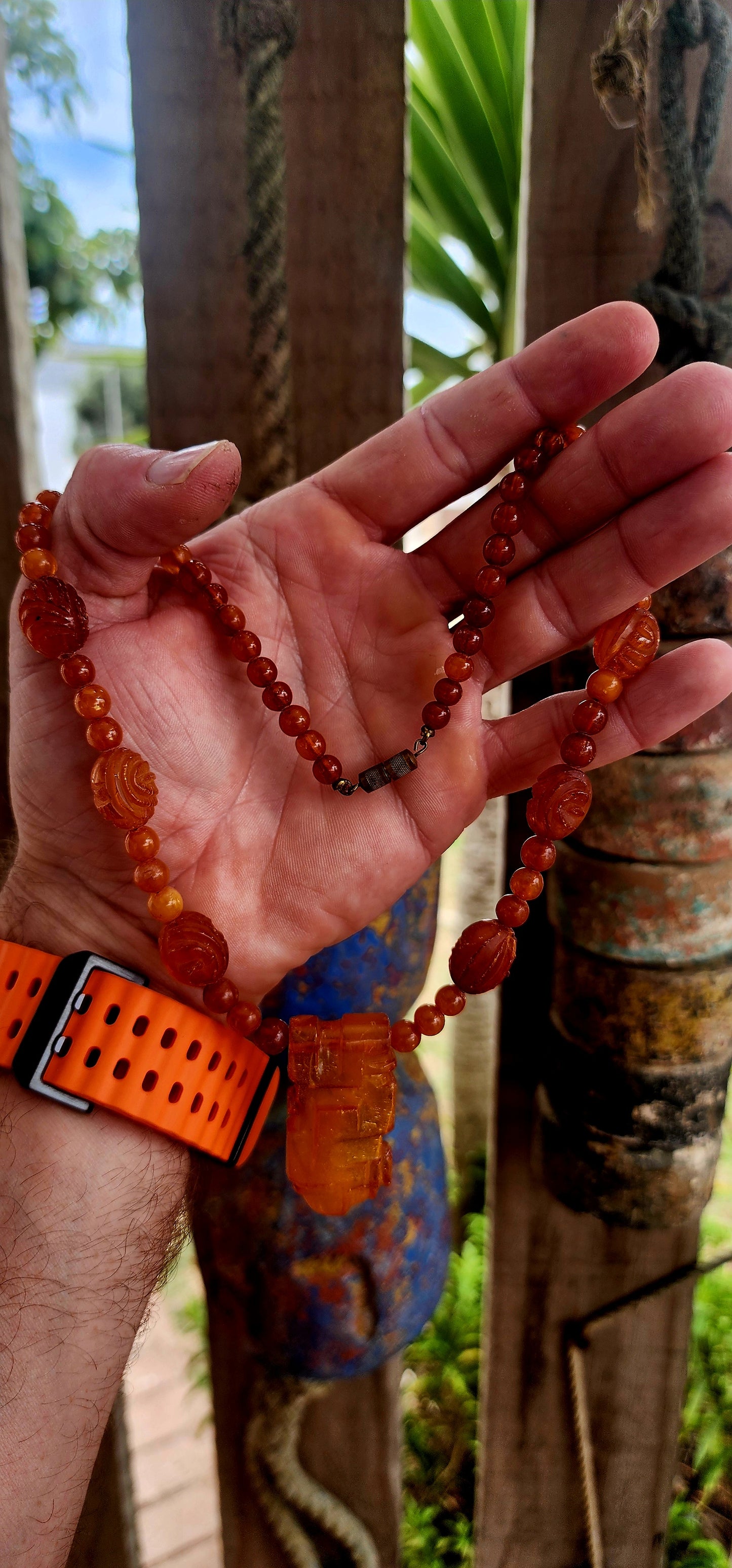 This marvelous Art Deco era (circa 1920s) Baltic amber necklace is crafted in a striking Aztec / Mesoamerican revival style.