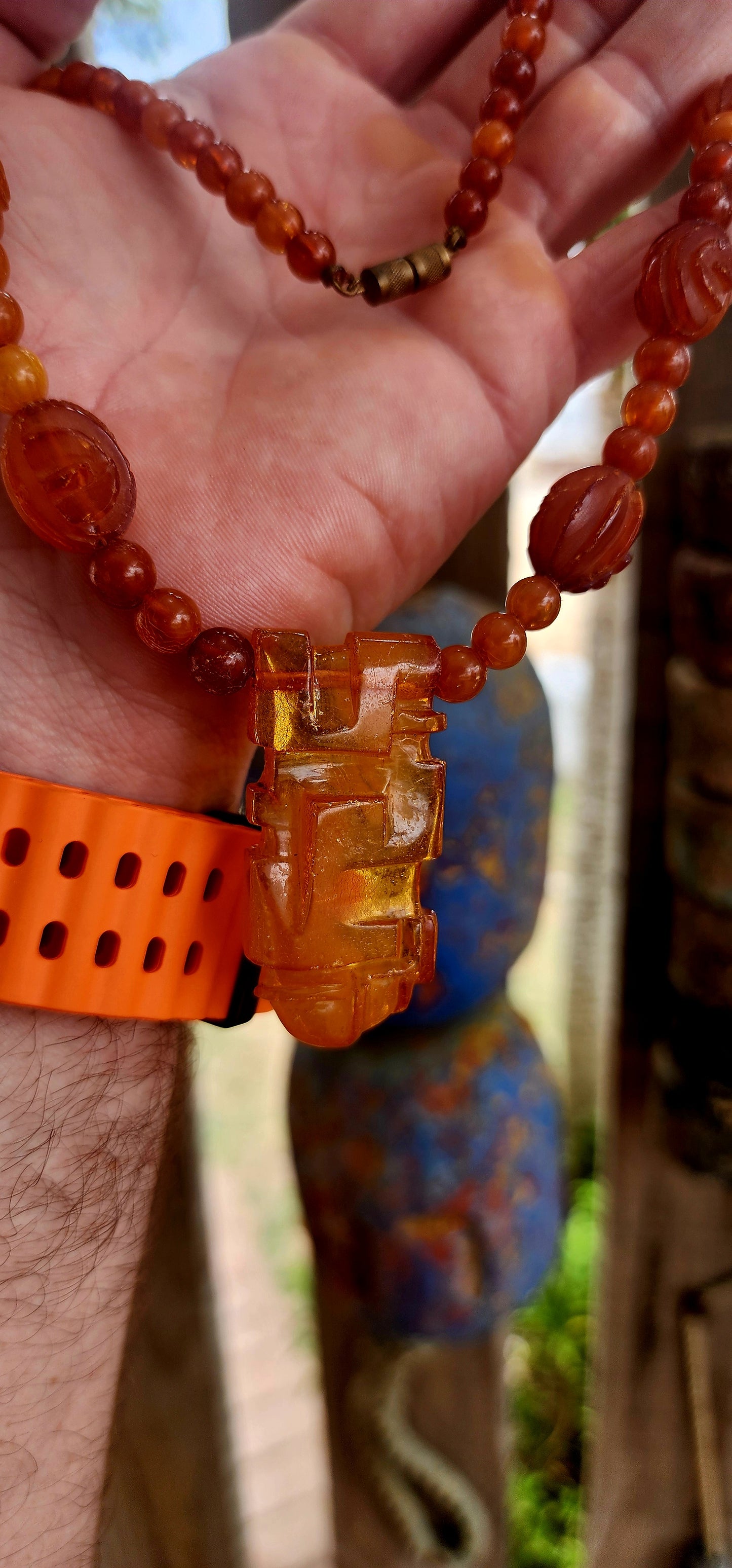 This marvelous Art Deco era (circa 1920s) Baltic amber necklace is crafted in a striking Aztec / Mesoamerican revival style.