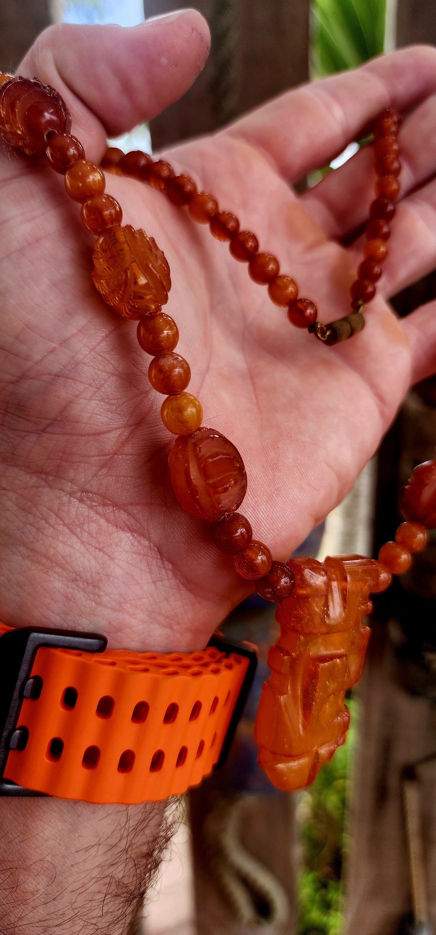 This marvelous Art Deco era (circa 1920s) Baltic amber necklace is crafted in a striking Aztec / Mesoamerican revival style.