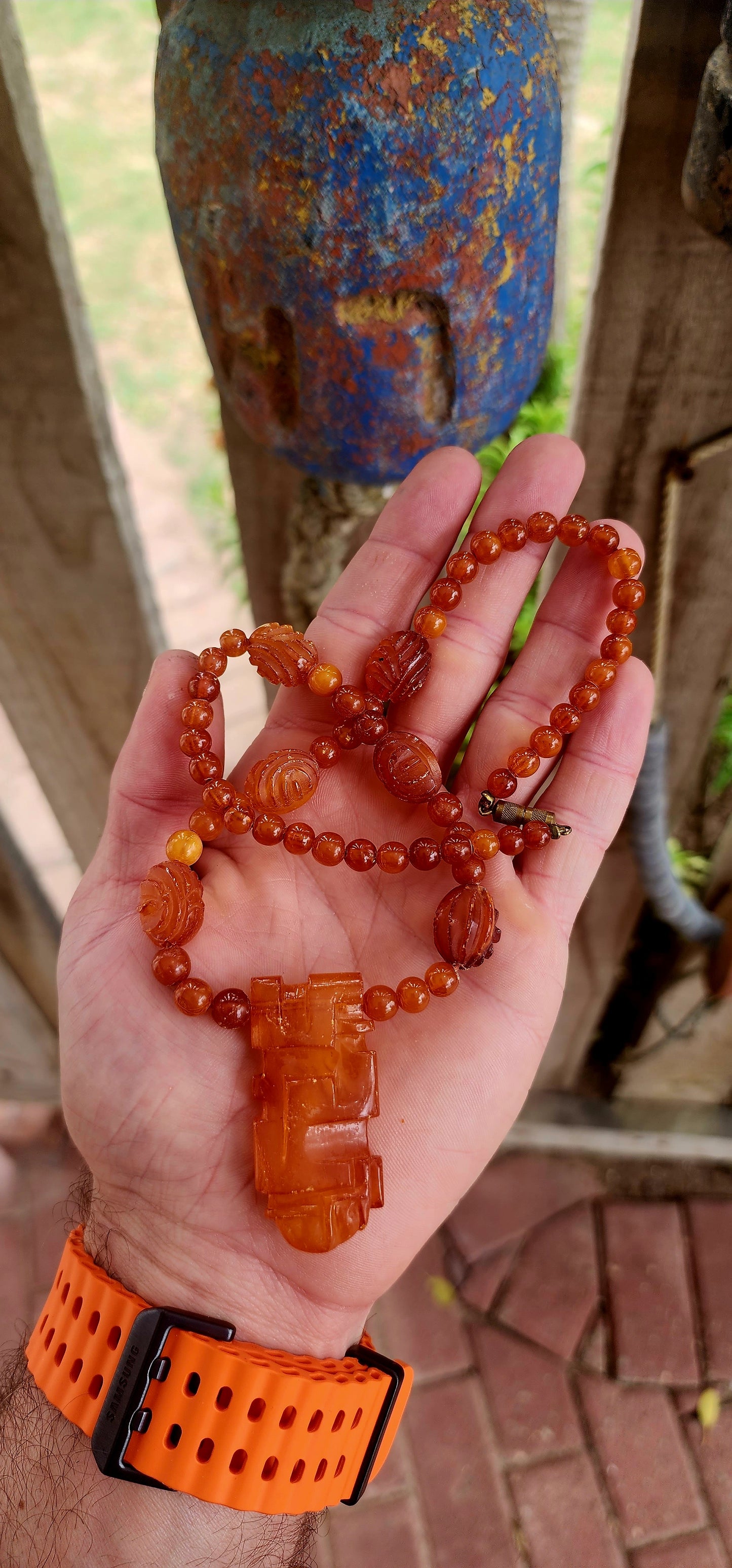 This marvelous Art Deco era (circa 1920s) Baltic amber necklace is crafted in a striking Aztec / Mesoamerican revival style.