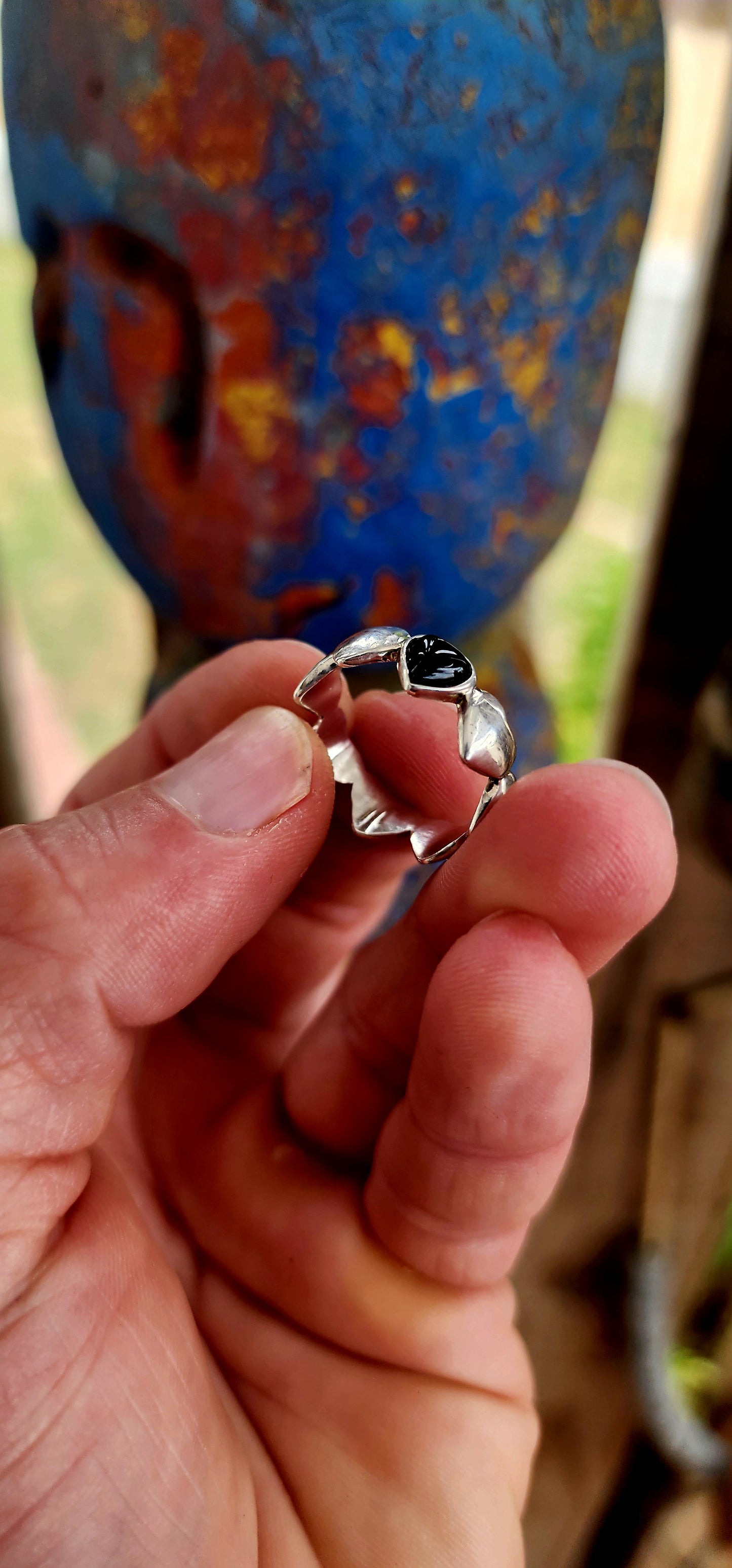 This artisan-made sterling silver ring is a full eternity style band featuring softly domed silver hearts wrapping all the way around the finger.