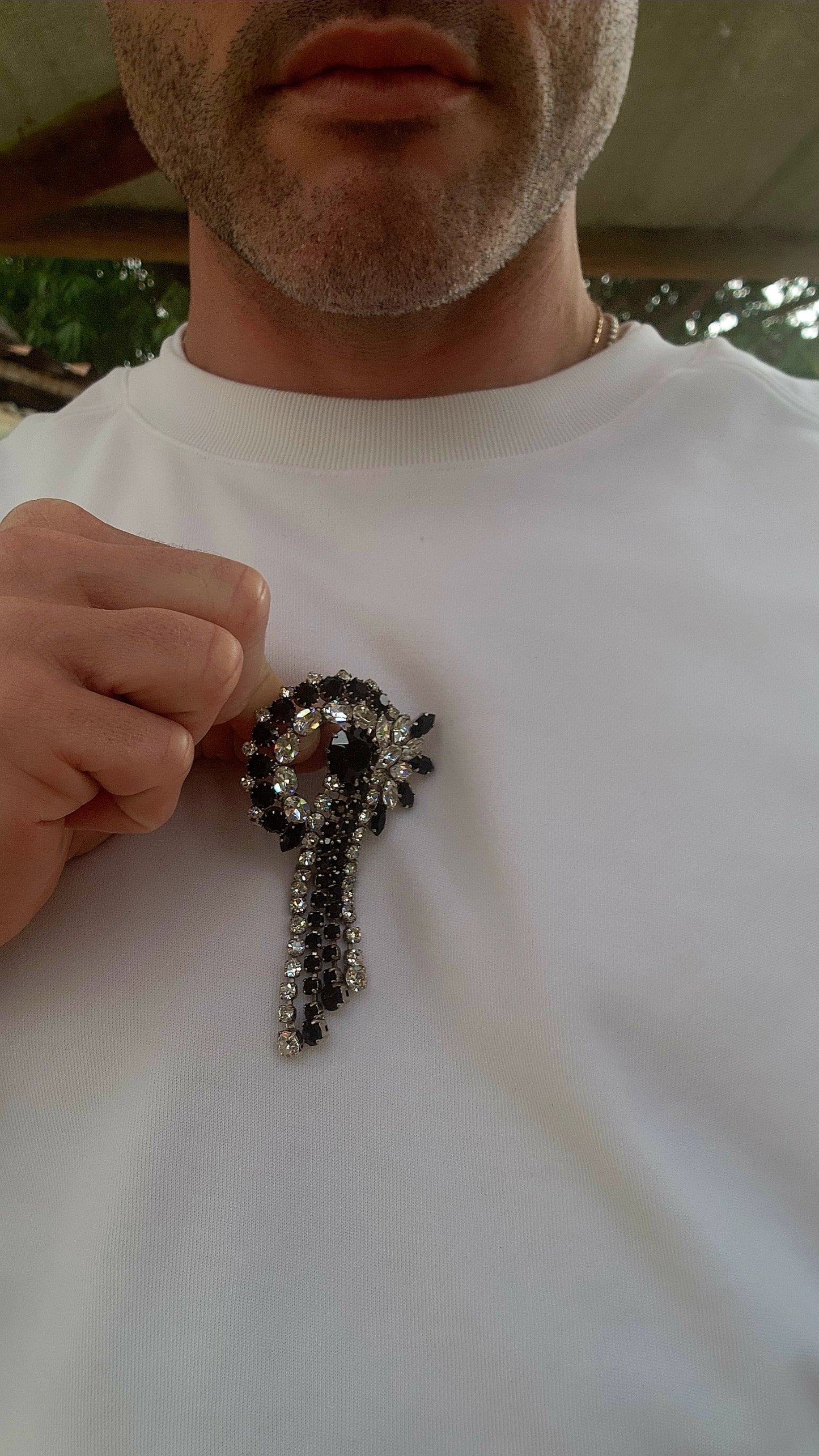 This breathtaking Art Deco era brooch is an absolute showstopper — crafted in silvertone metal and lavishly adorned with prong-set crystal rhinestones in striking shades of jet black and brilliant clear..