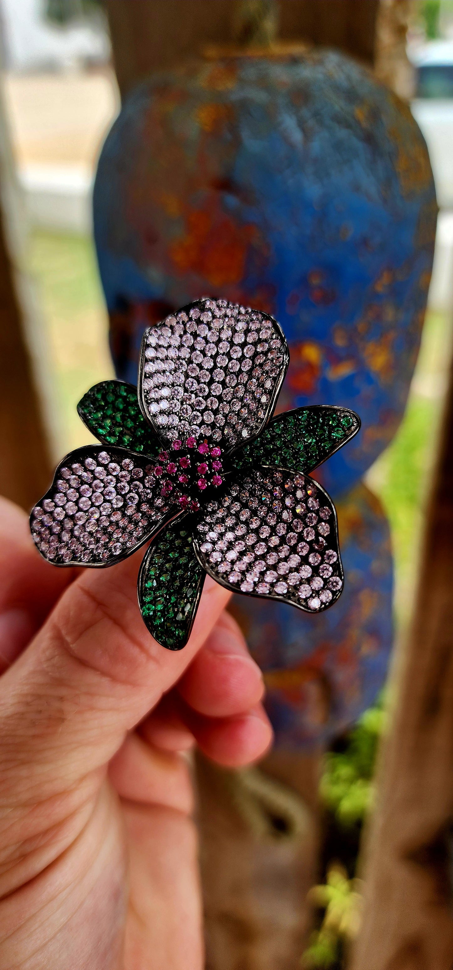 A magical, three-dimensional flower brought to life in rich blackened sterling silver — giving it that moody, gothic, almost midnight-garden energy.