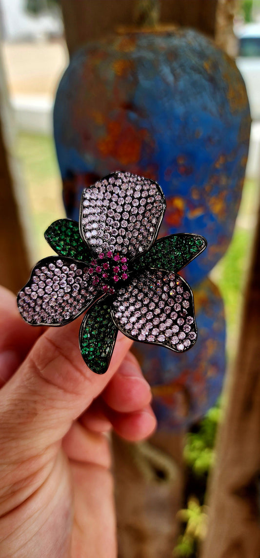 A magical, three-dimensional flower brought to life in rich blackened sterling silver — giving it that moody, gothic, almost midnight-garden energy.