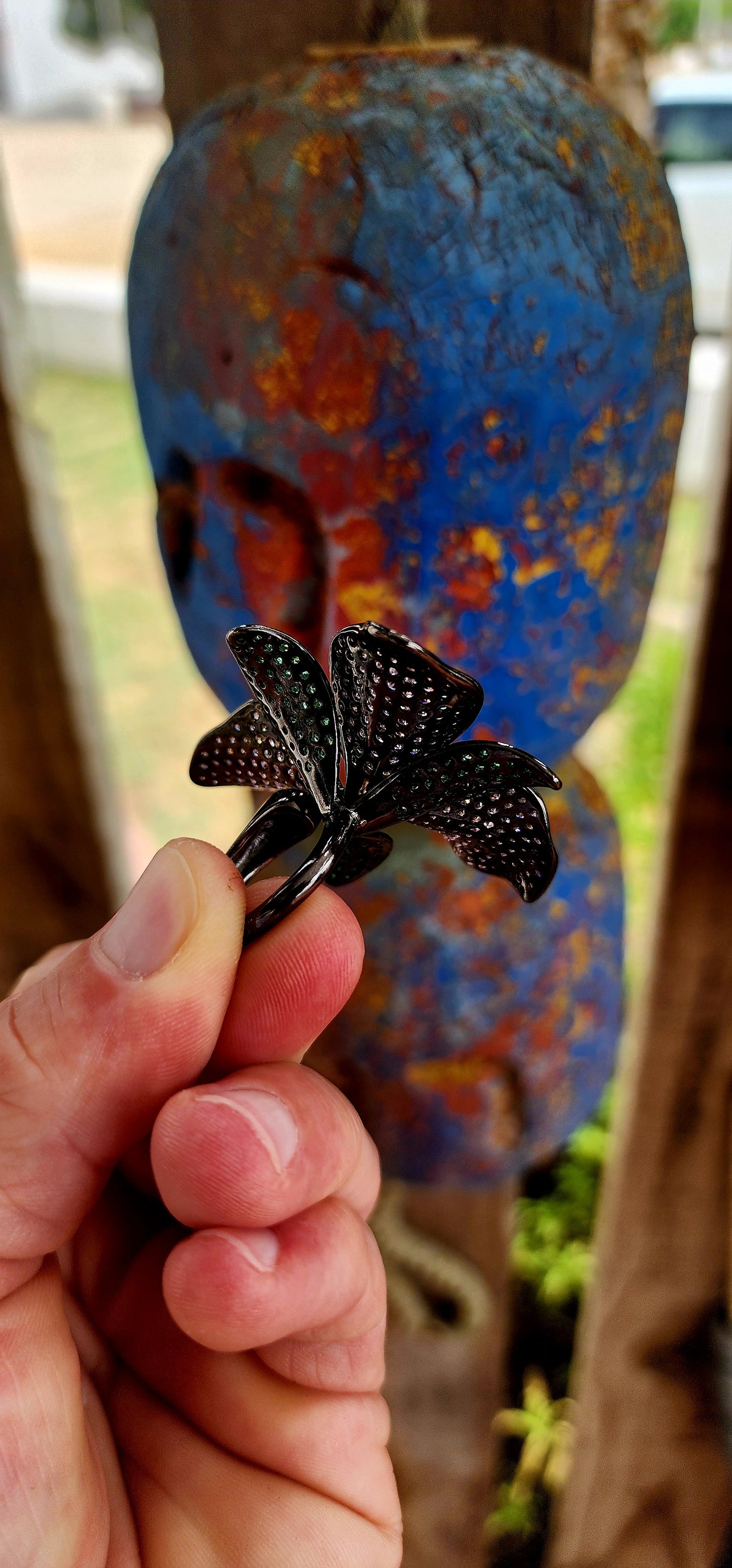 A magical, three-dimensional flower brought to life in rich blackened sterling silver — giving it that moody, gothic, almost midnight-garden energy.