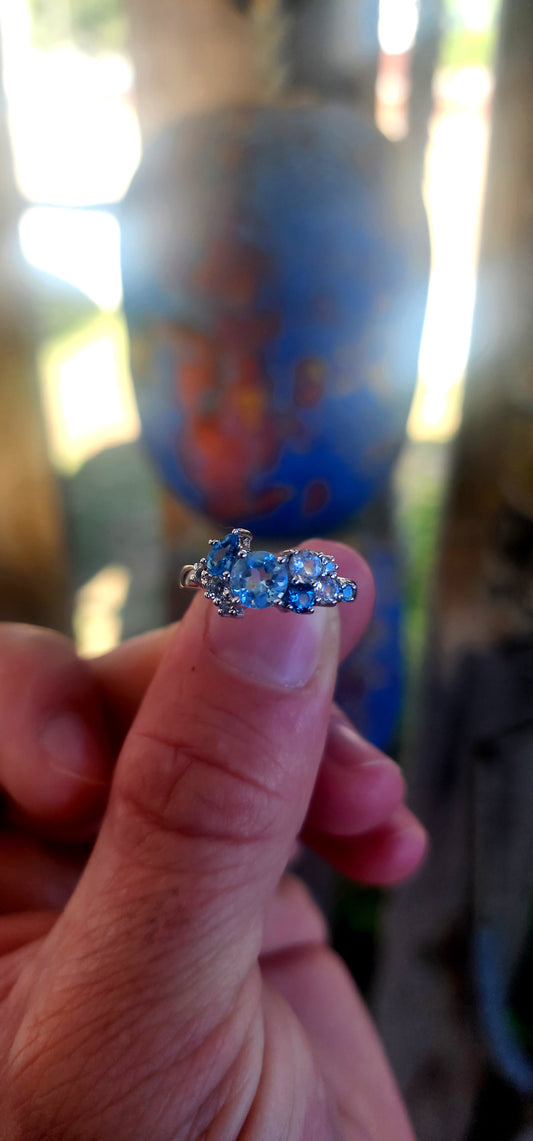 Crafted in solid sterling silver and finished with rhodium plating for a bright, tarnish-resistant white-gold look, this ring is a tribute to the beauty of topaz in all its shades of blue.