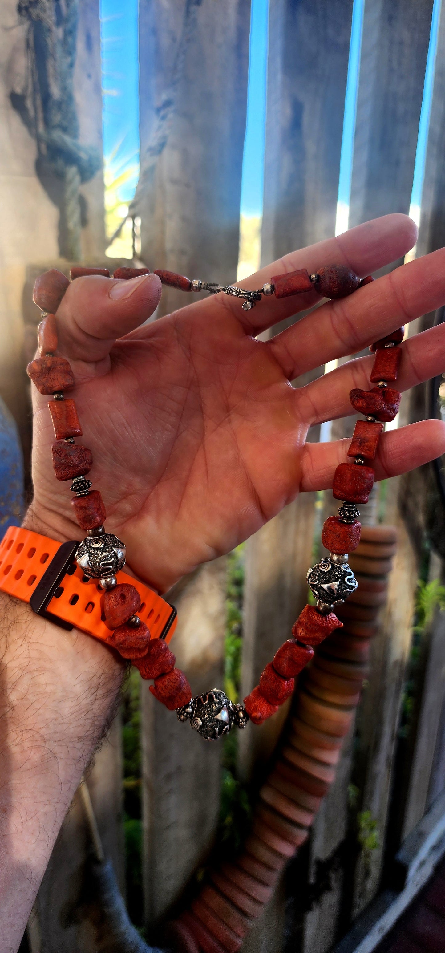 This chunky artisan-made necklace is crafted in solid sterling silver and strung with beautifully irregular, semi-polished natural Mediterranean coral beads.