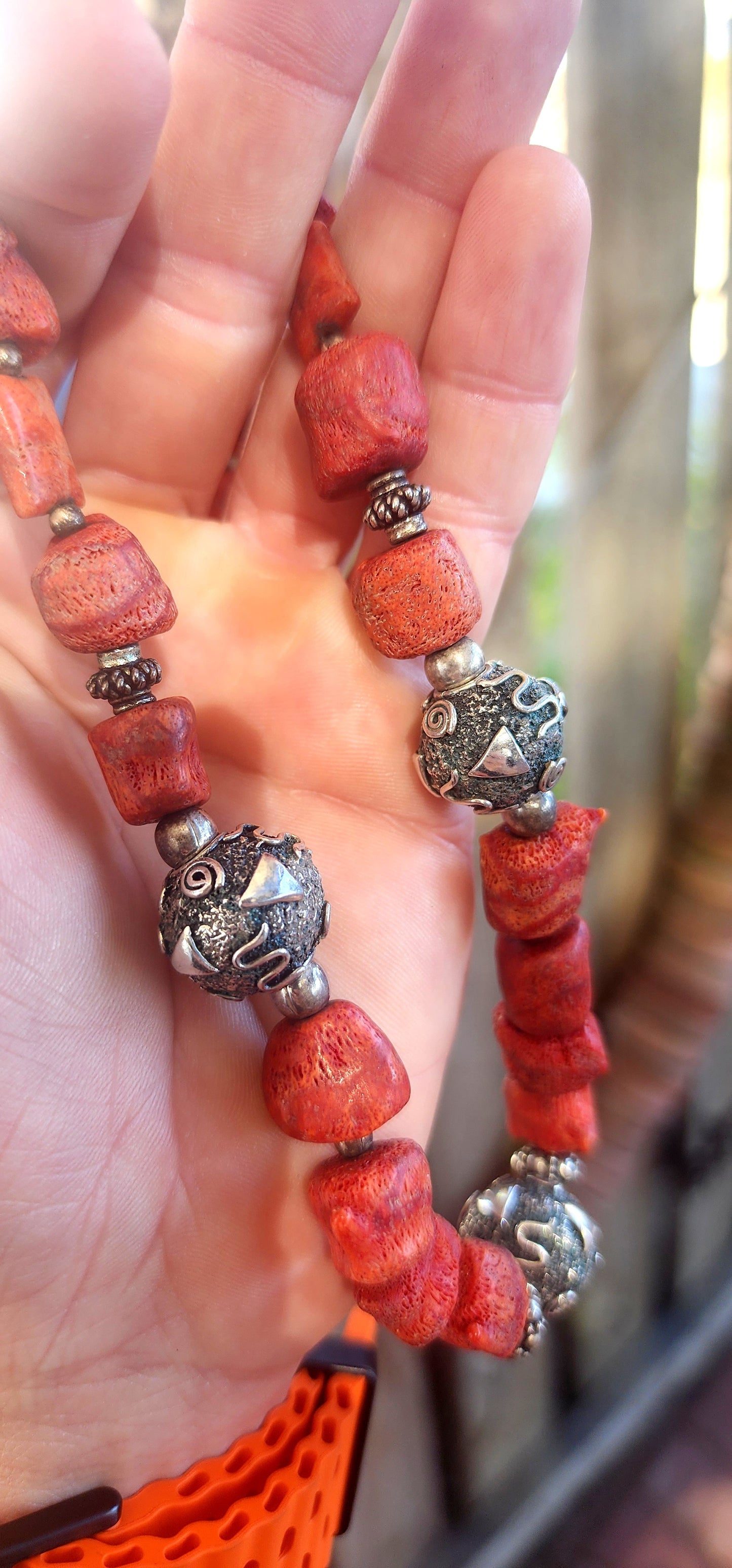 This chunky artisan-made necklace is crafted in solid sterling silver and strung with beautifully irregular, semi-polished natural Mediterranean coral beads.