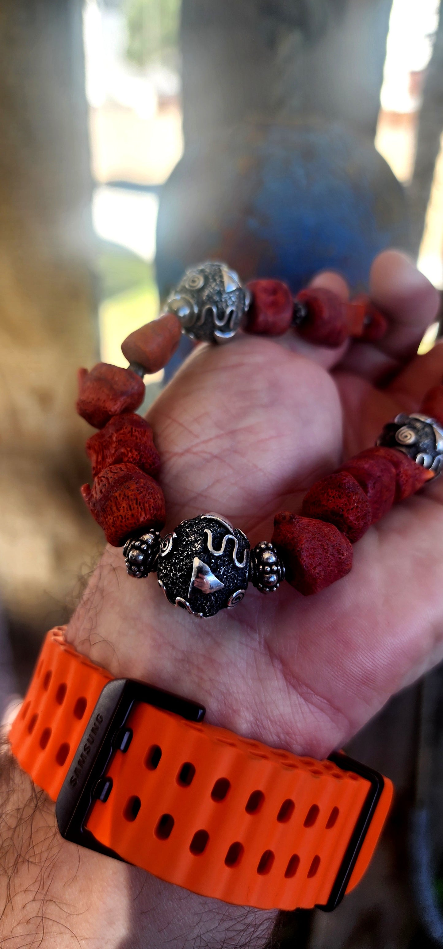 This chunky artisan-made necklace is crafted in solid sterling silver and strung with beautifully irregular, semi-polished natural Mediterranean coral beads.