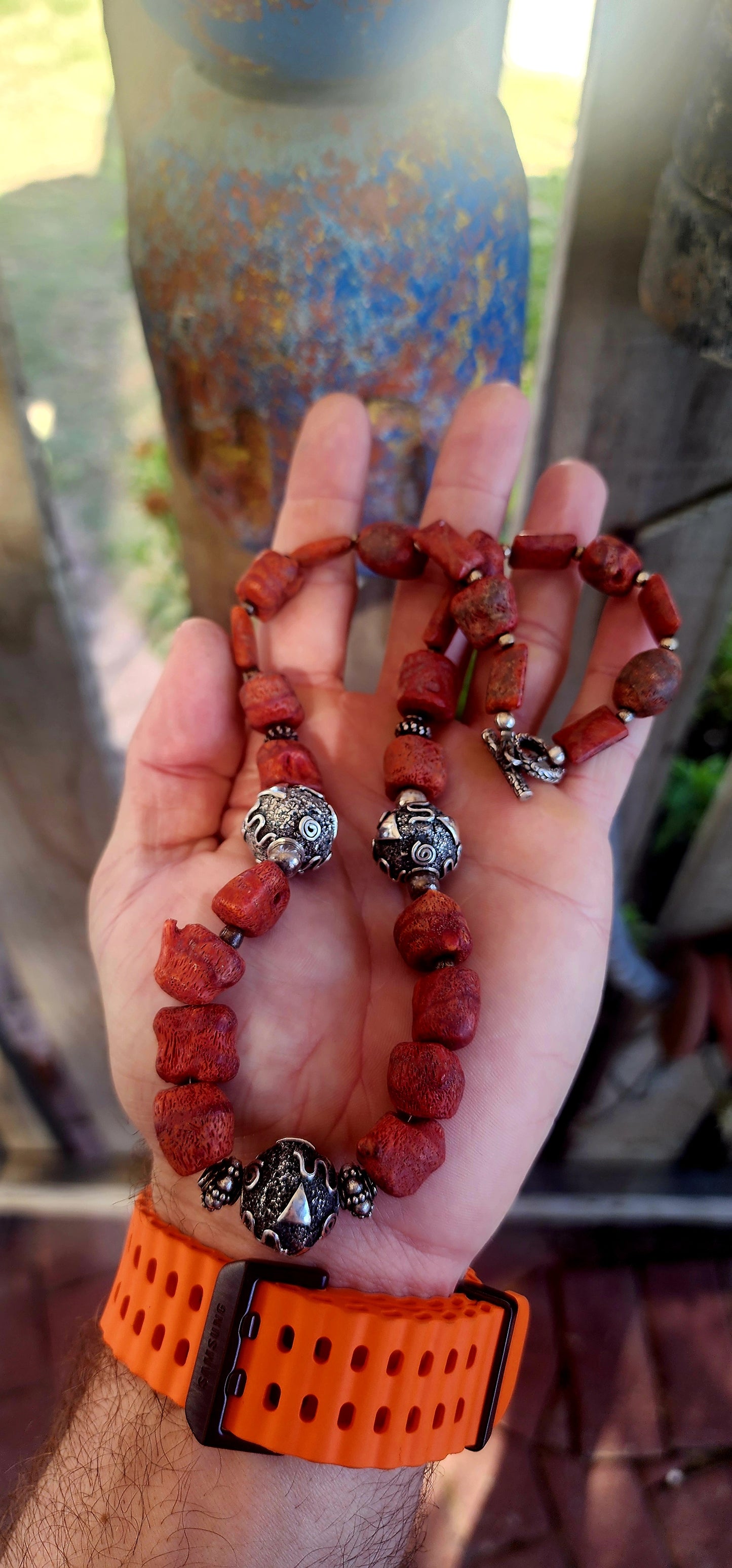 This chunky artisan-made necklace is crafted in solid sterling silver and strung with beautifully irregular, semi-polished natural Mediterranean coral beads.